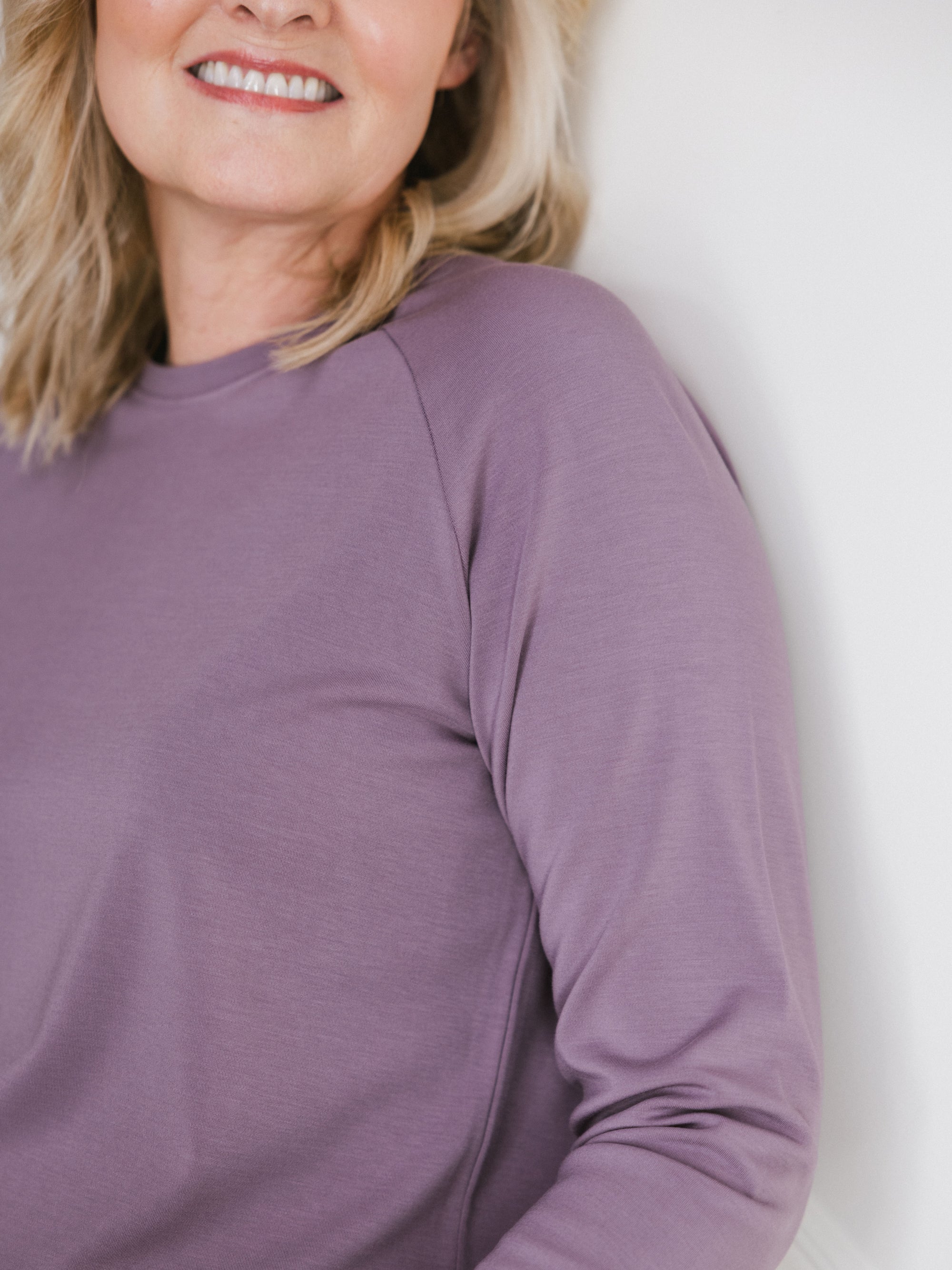 Twilight Bamboo Jogger Set modeled by a woman. The photo was taken in a high contrast setting, showing off the colors and lines of the pajamas. 