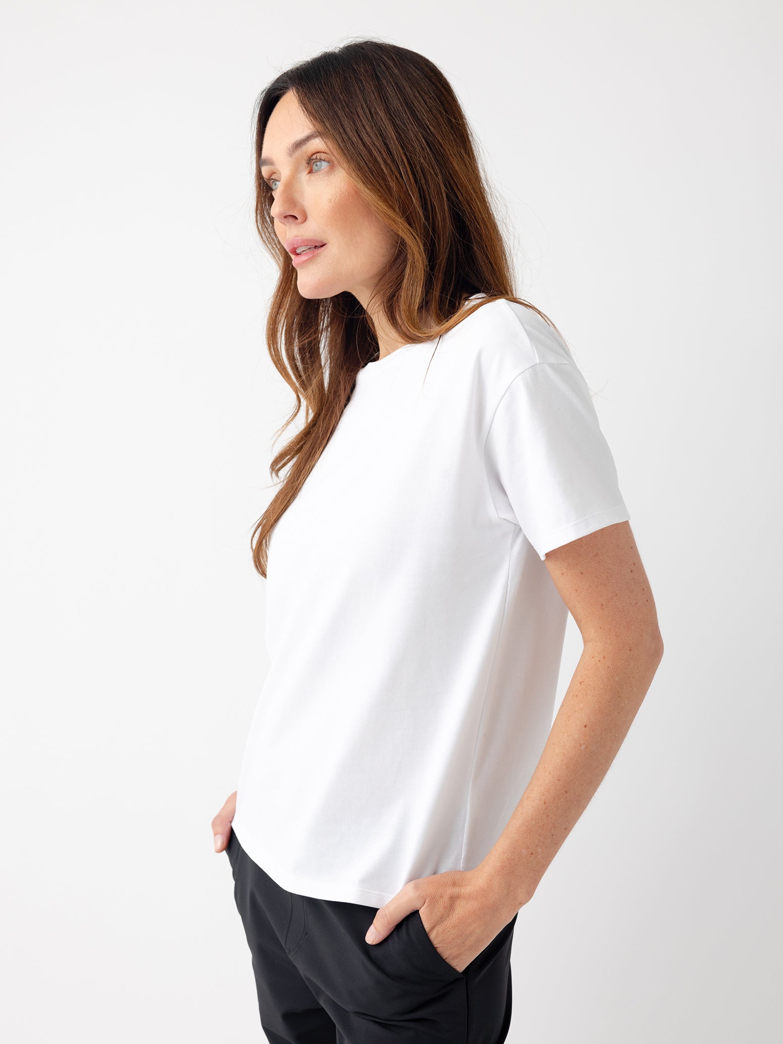 Woman wearing white tee with white background 