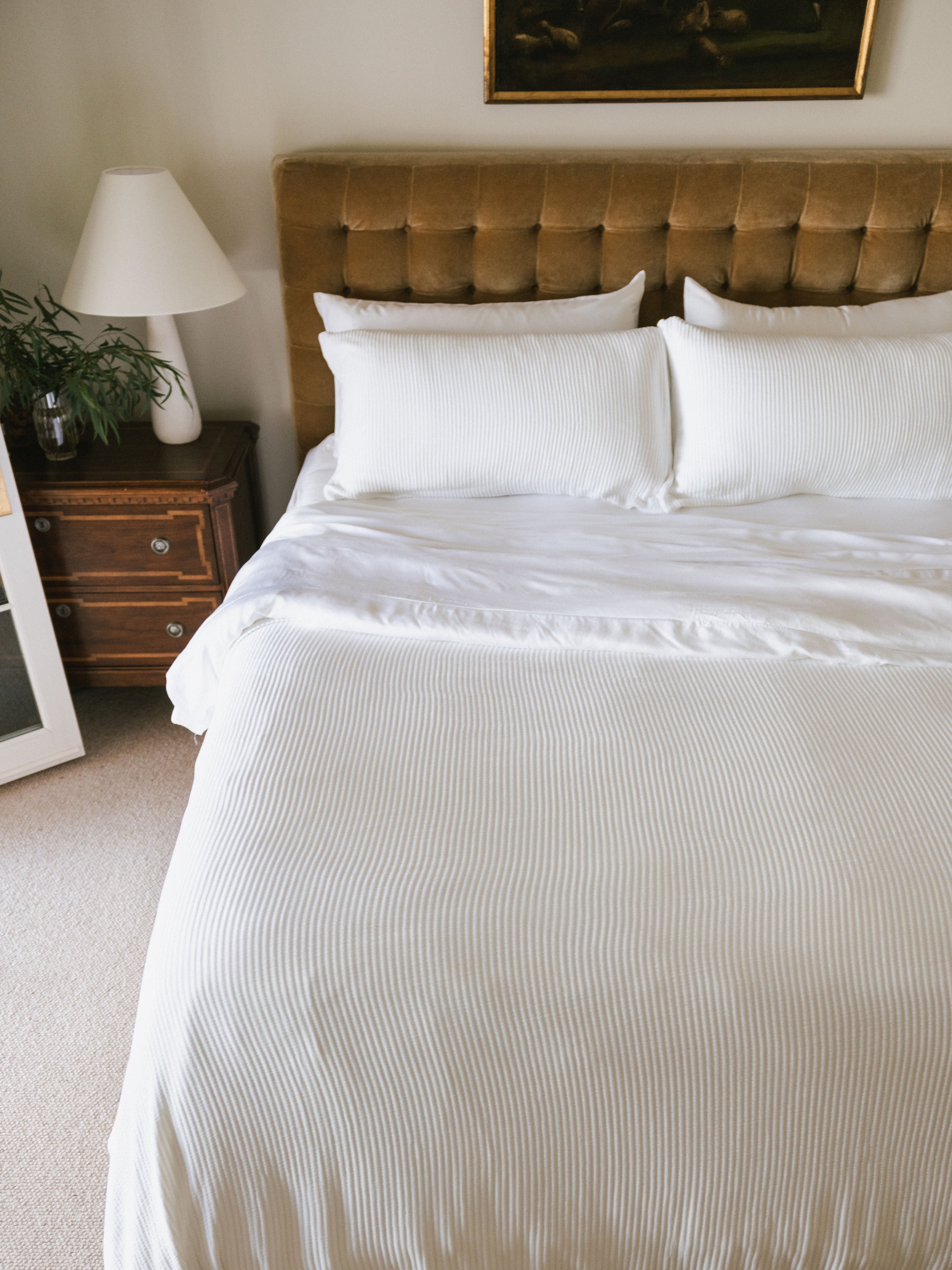 White coverlet and shams on a bed 