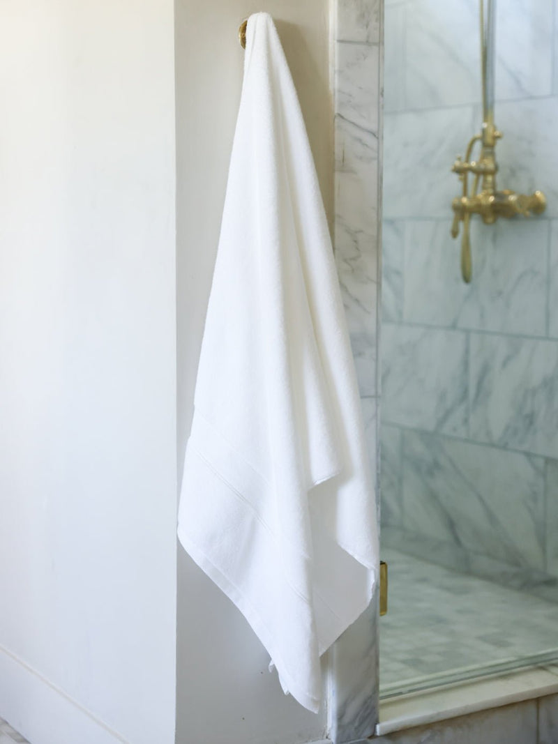 White luxe bath sheet hanging next to the shower