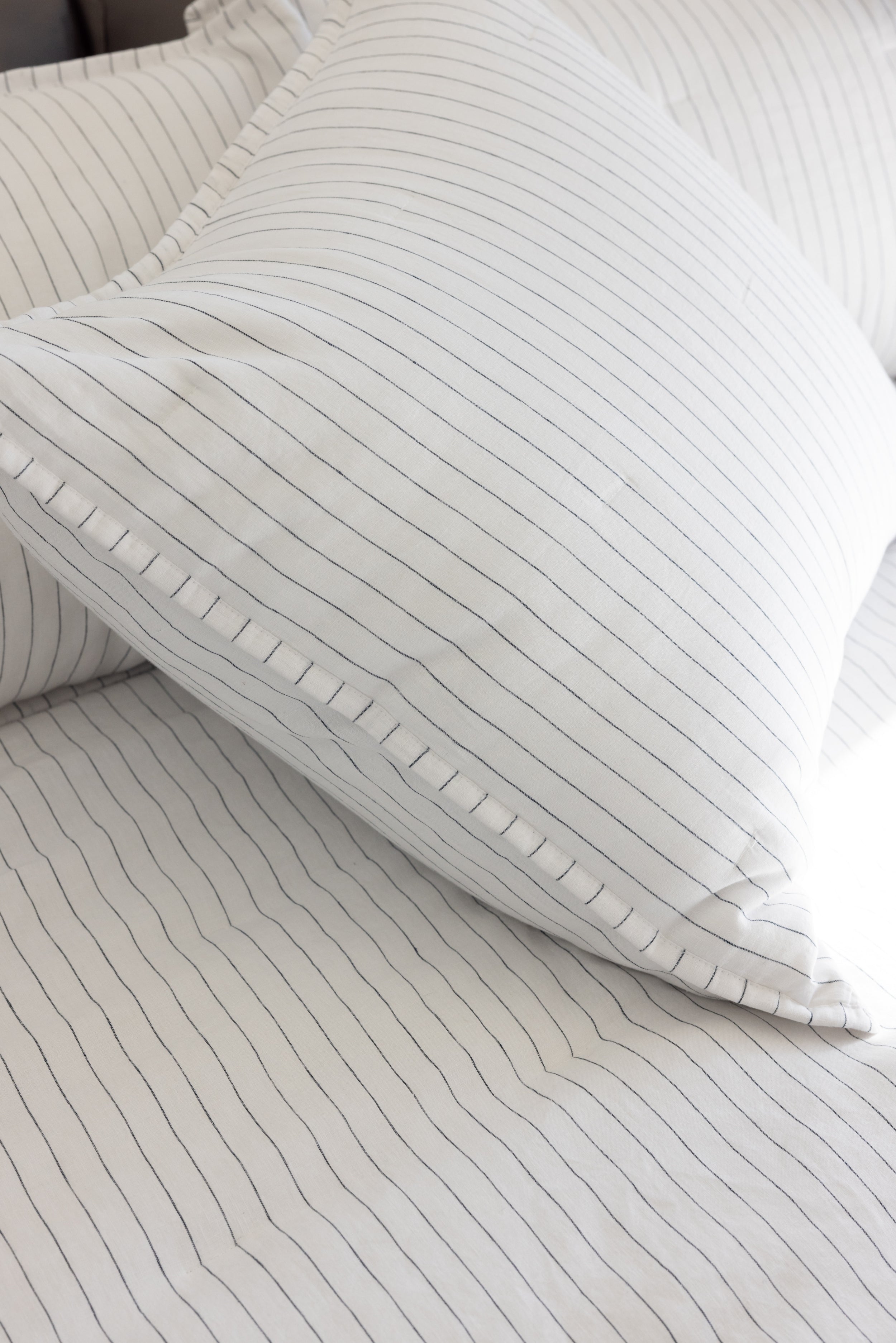 Close up of charcoal pencil stripe shams on bed |Size:Standard|Color:Charcoal/White
