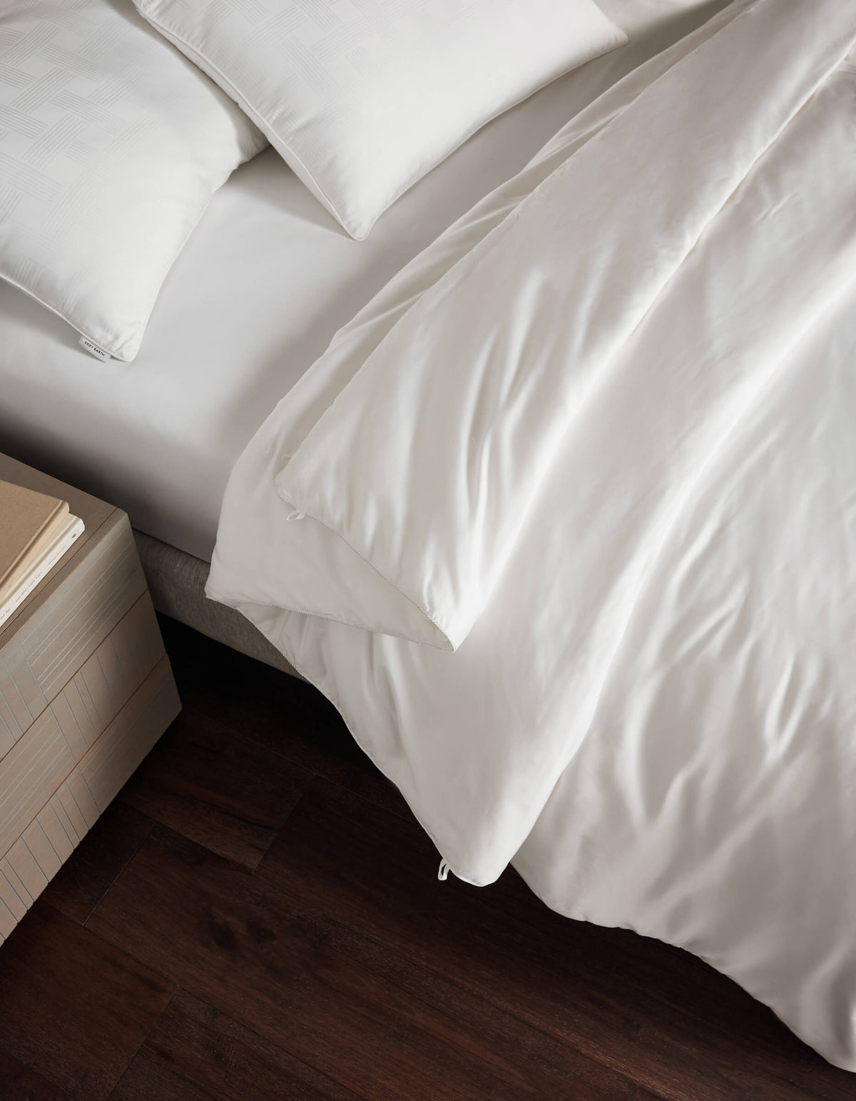 a bed with white comforter