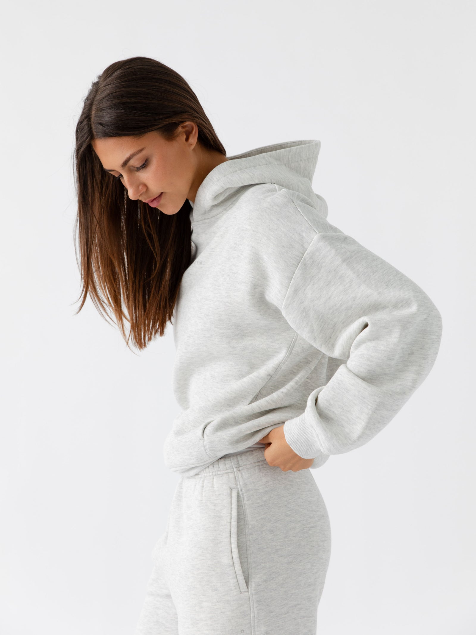 Side view of woman wearing heather grey cityscape hoodie set 