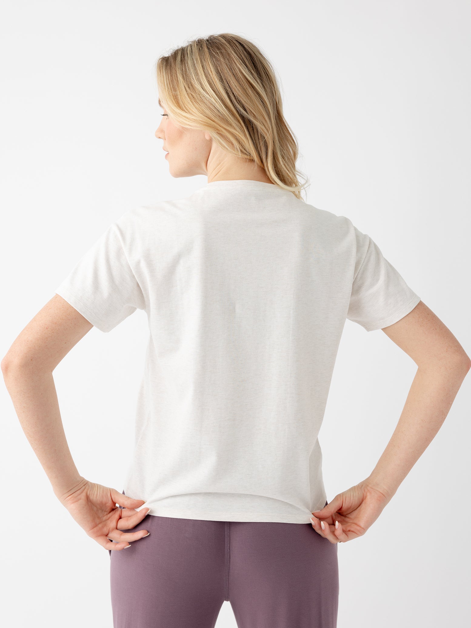 Back of woman in alabaster tee 