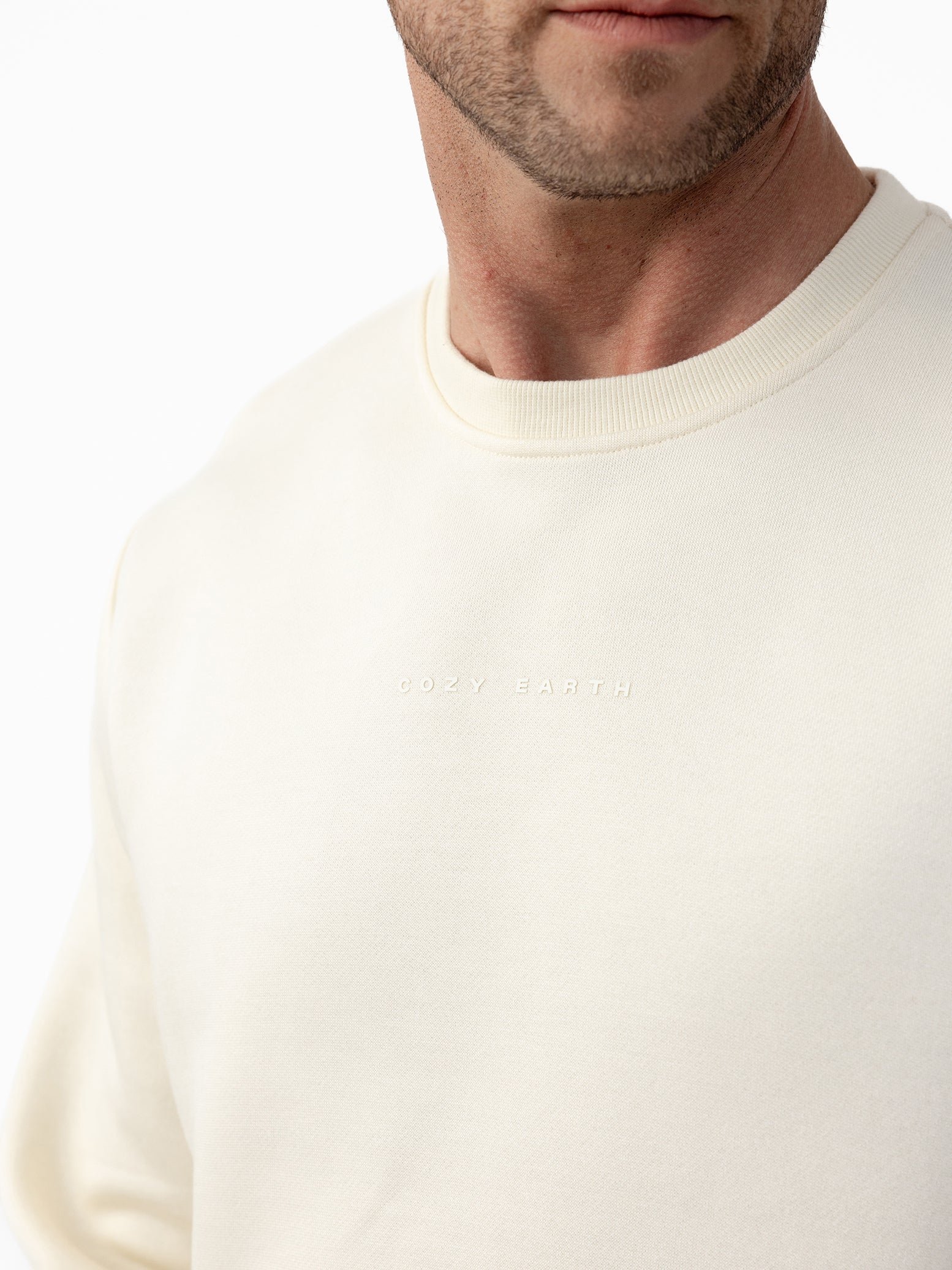 Man wearing Alabaster cityscape crewneck with white background 