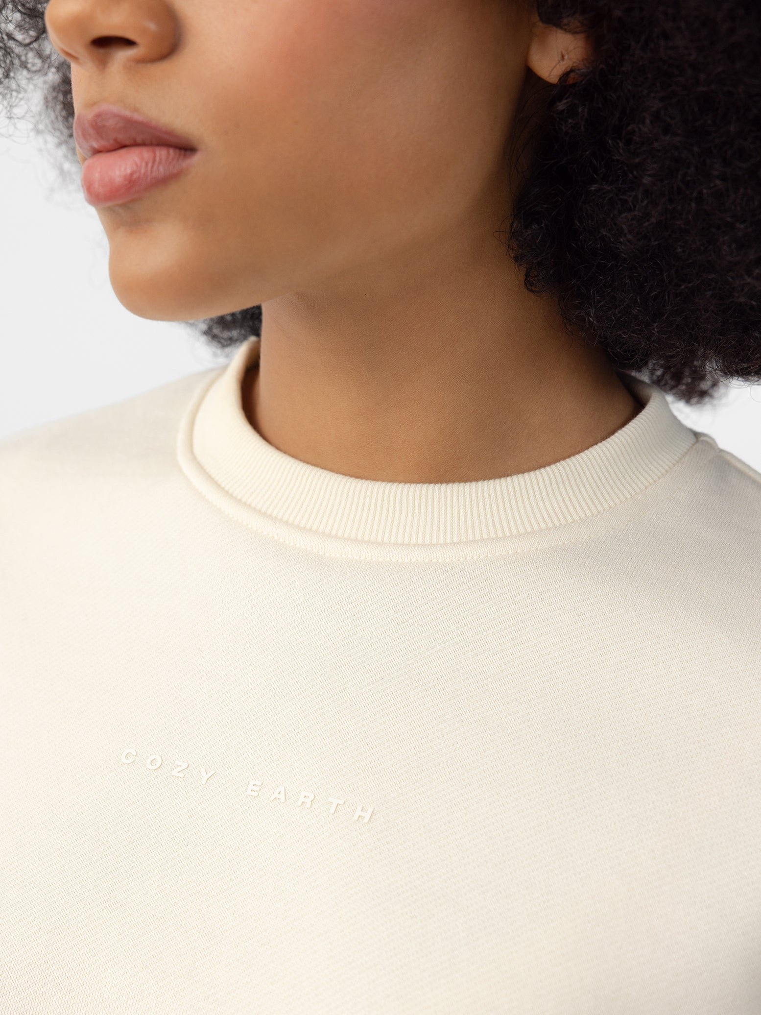 Woman wearing Alabaster CityScape Crewneck with white background 