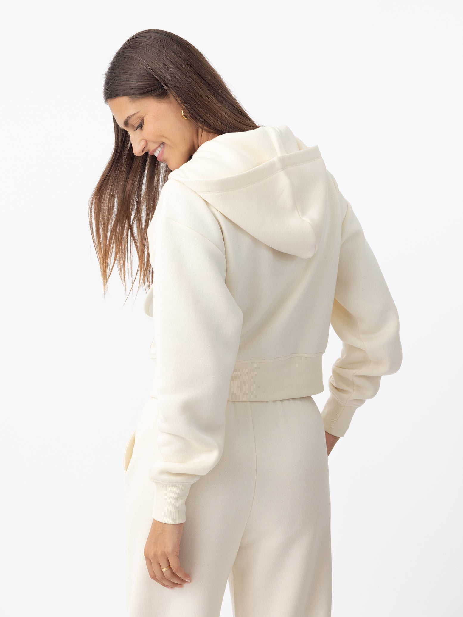 Woman wearing Alabaster CityScape Cropped Full Zip with white background 