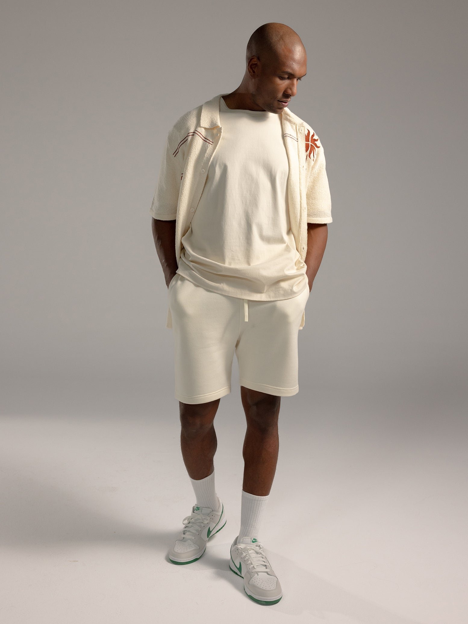 Man wearing Alabaster CityScape Shorts with grey background 