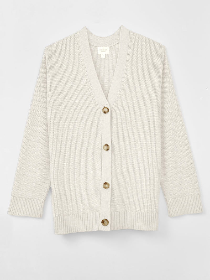 A woman wearing Cozy Earth Classic Cardigan is pictured on a white background