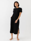 Black Bamboo Midi Dress modeled by a woman. The photo was taken in a high contrast setting, showing off the colors and lines of the dress. |Color: Black