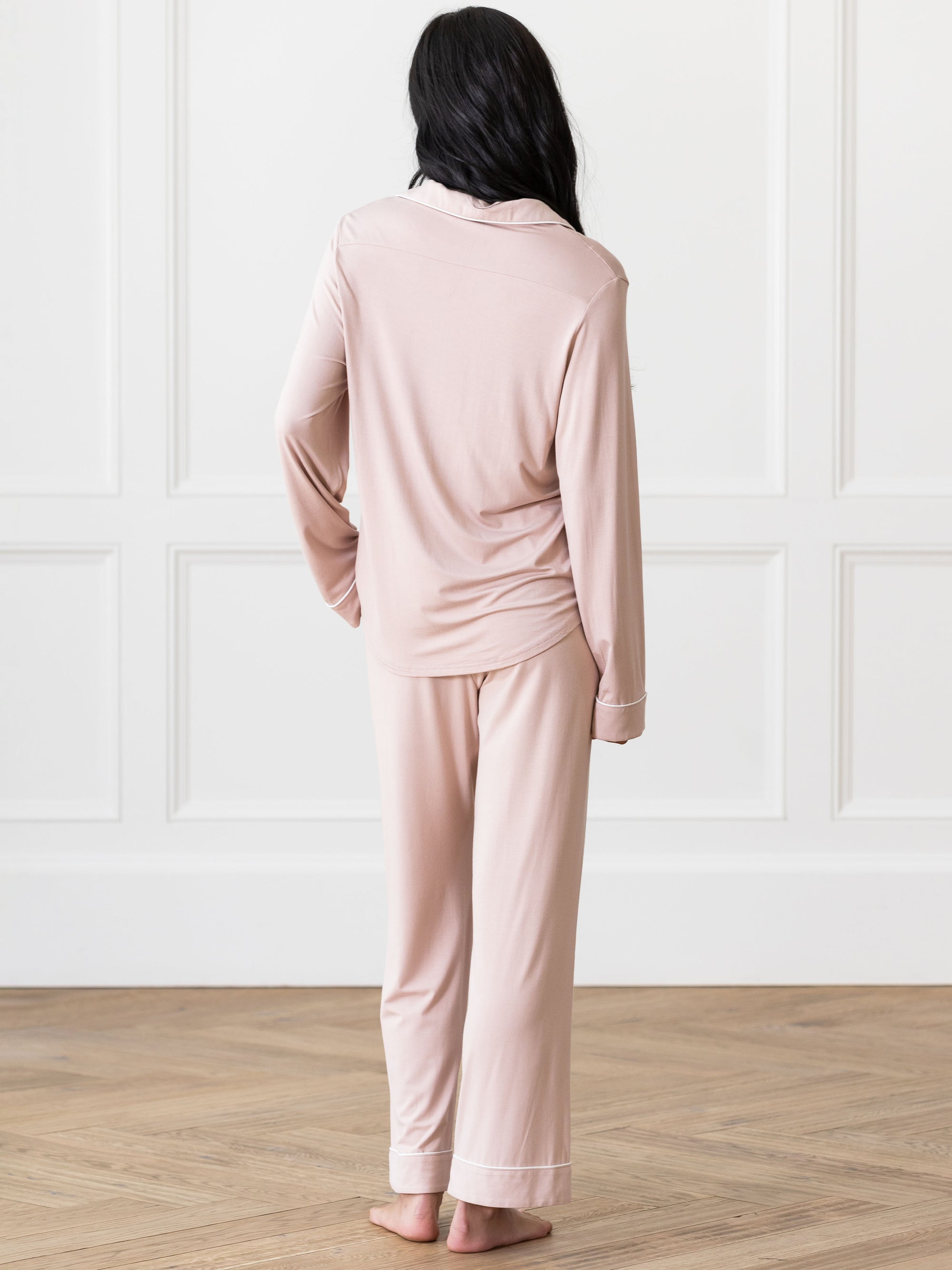 Blush Long Sleeve Pajama Set modeled by a woman. The photo was taken in a high contrast setting, showing off the colors and lines of the pajamas. 