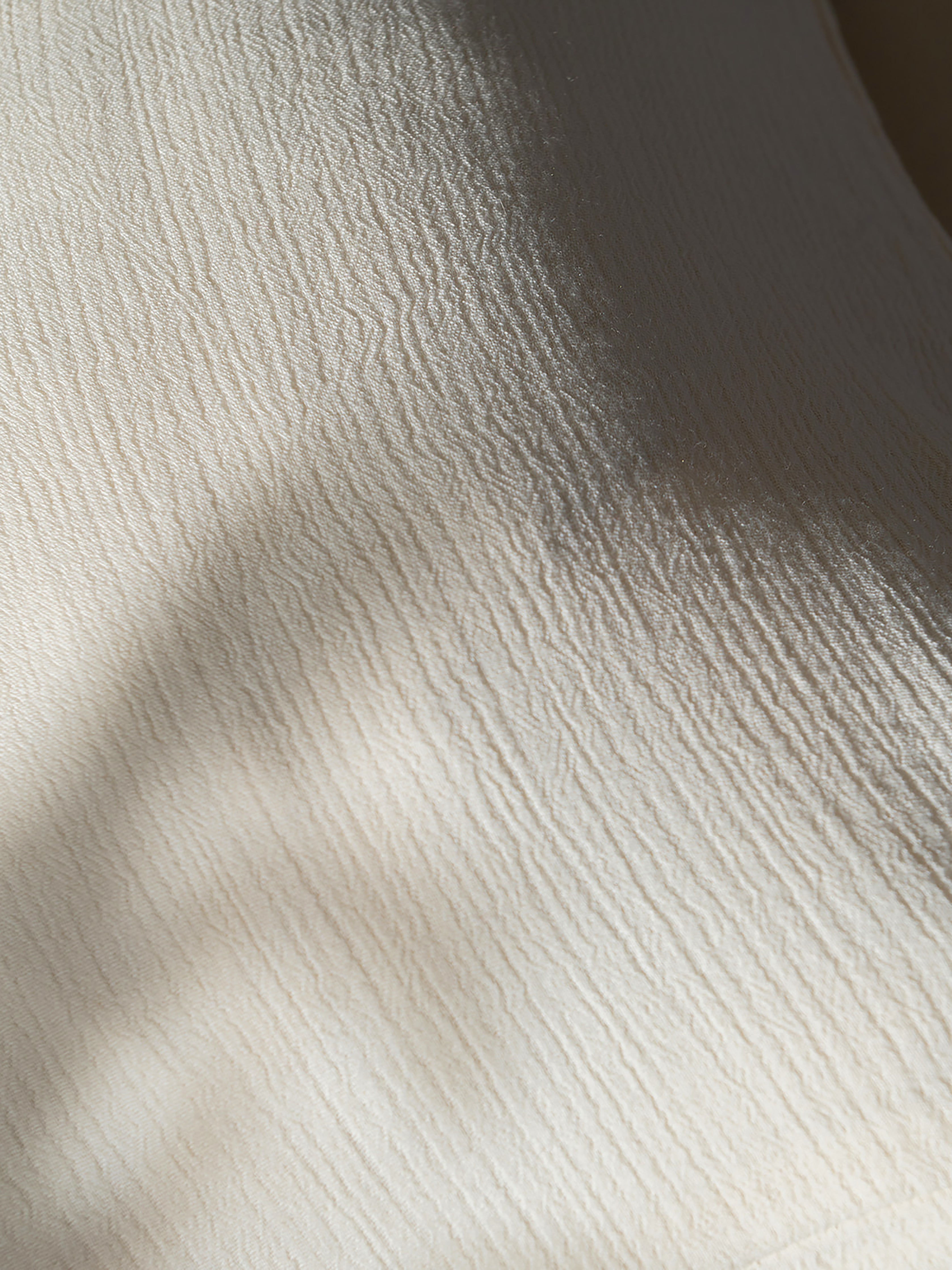 Close up of Buttermilk Aire Bamboo Sham. The sham is photographed close up resting on a bed|Color:Buttermilk|Size:Euro