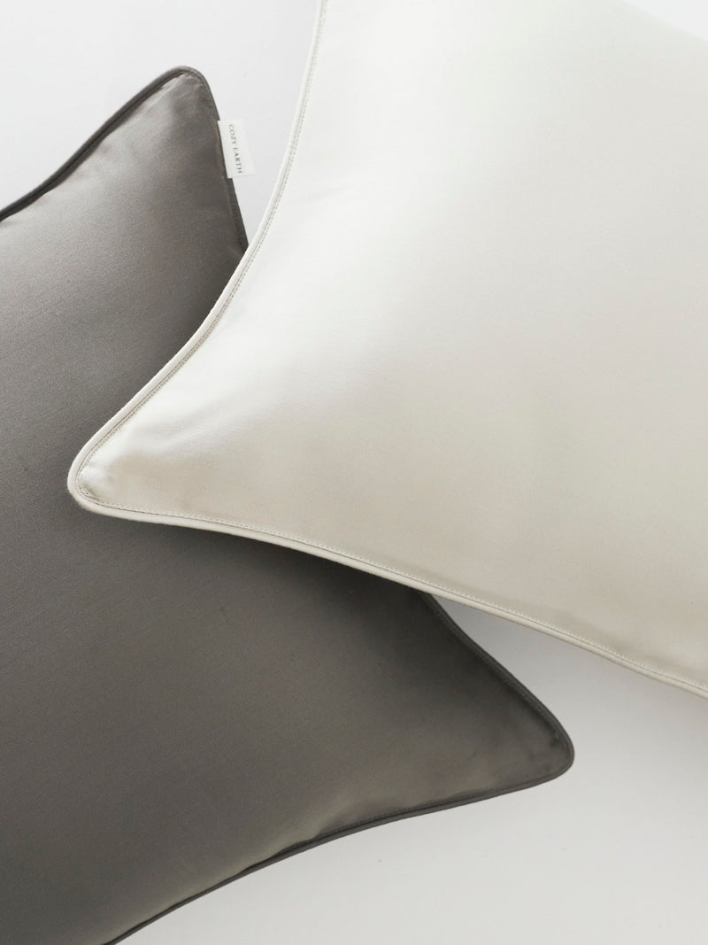 Close up of charcoal and light grey travel pillowcases