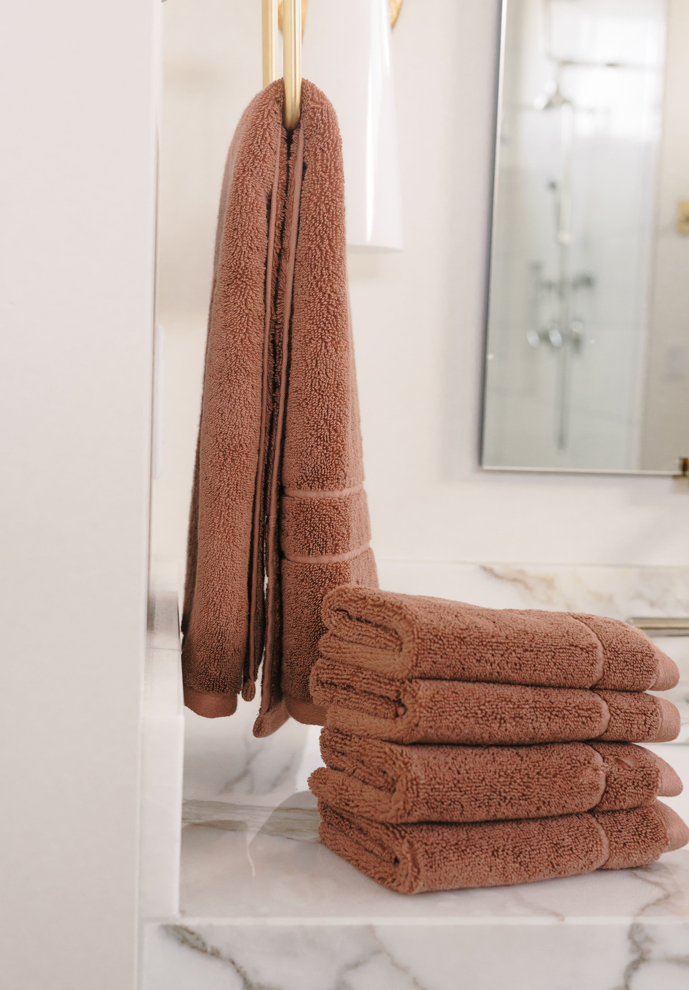 Clay Premium Plush Wash Cloths. Photo of Premium Plush Wash Cloths taken with in a white bathroom with marble counter tops. 