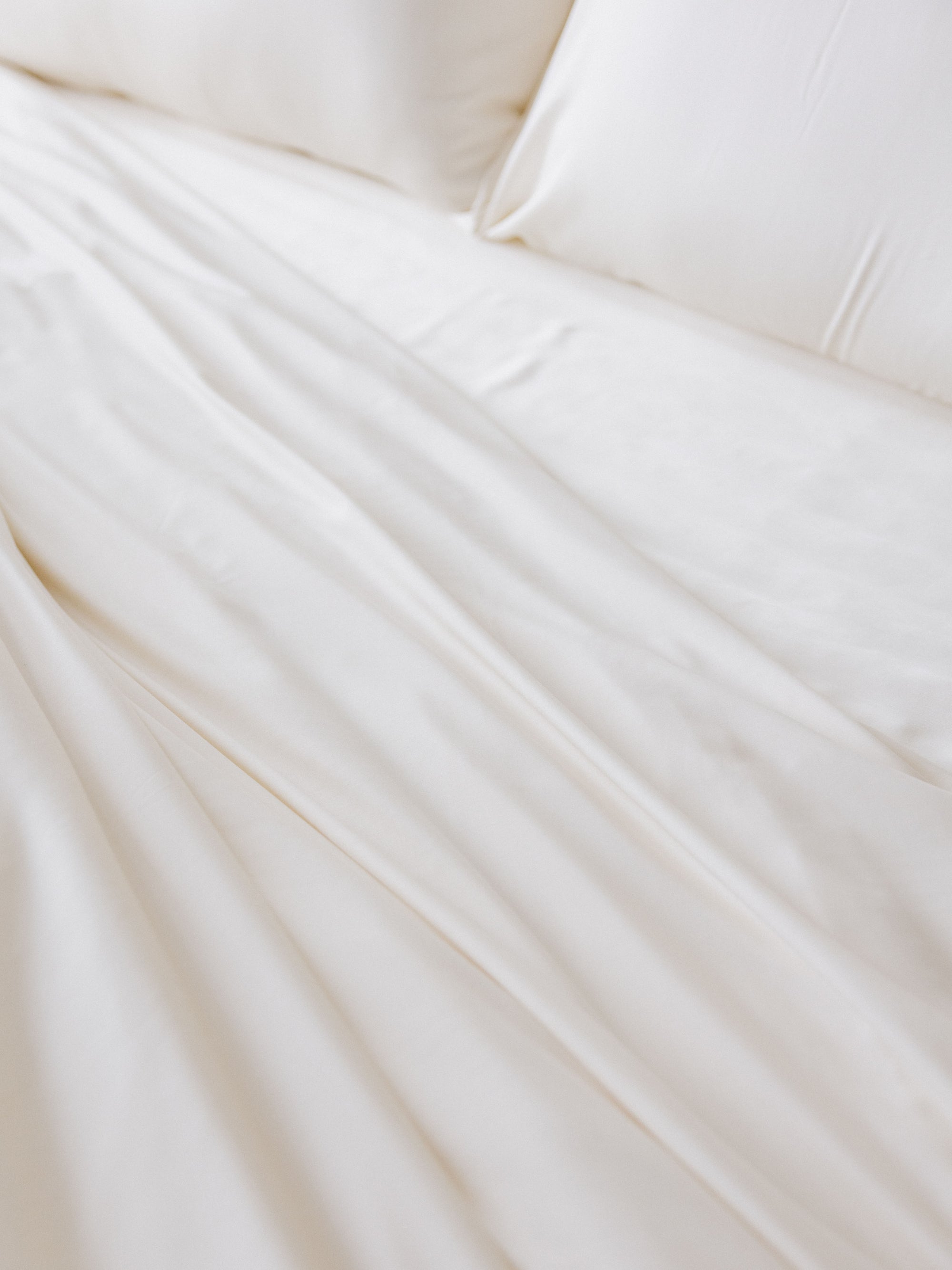 Close up of creme bedding on bed 
