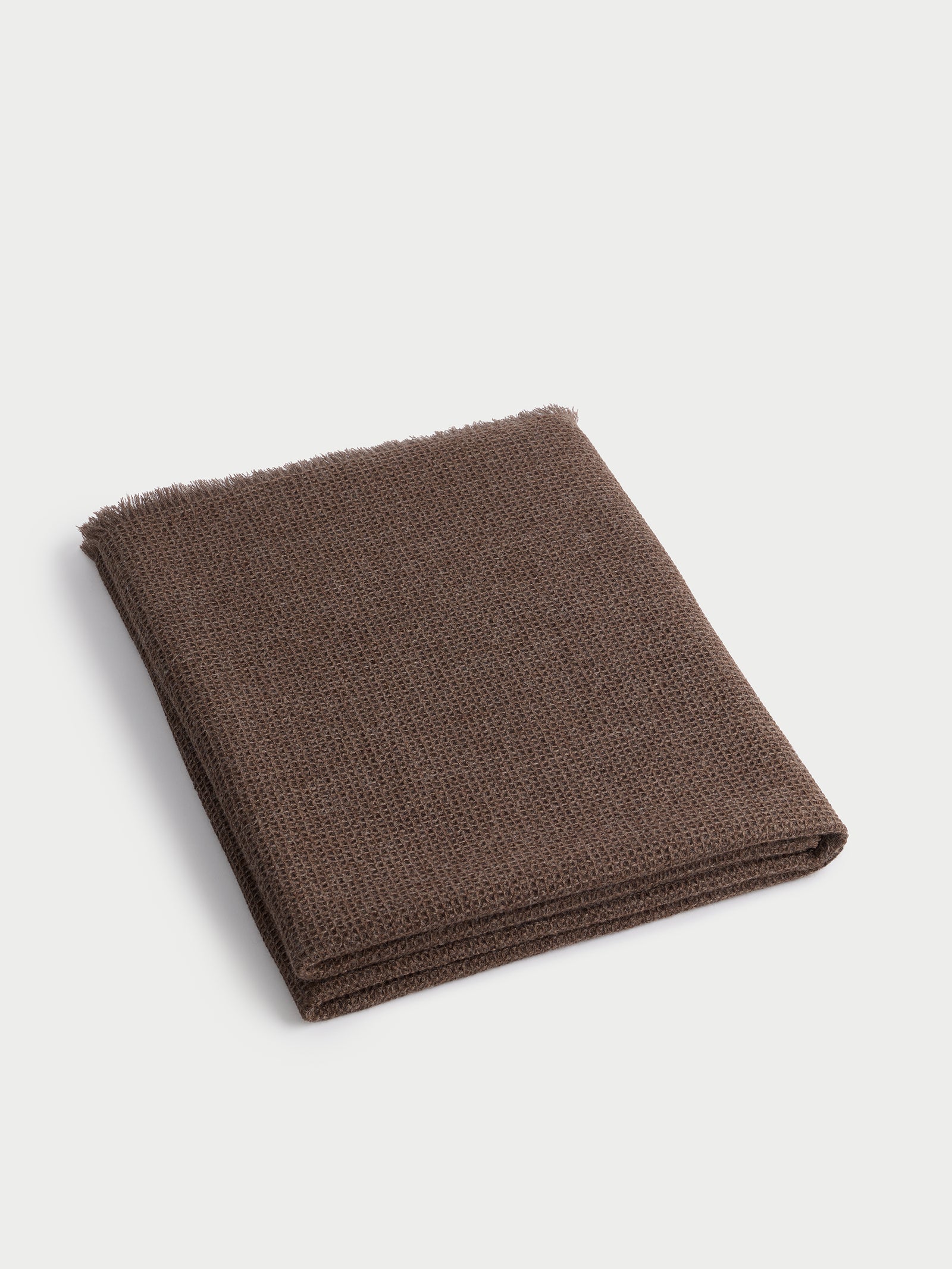 Ebony alpaca throw folded with white background 