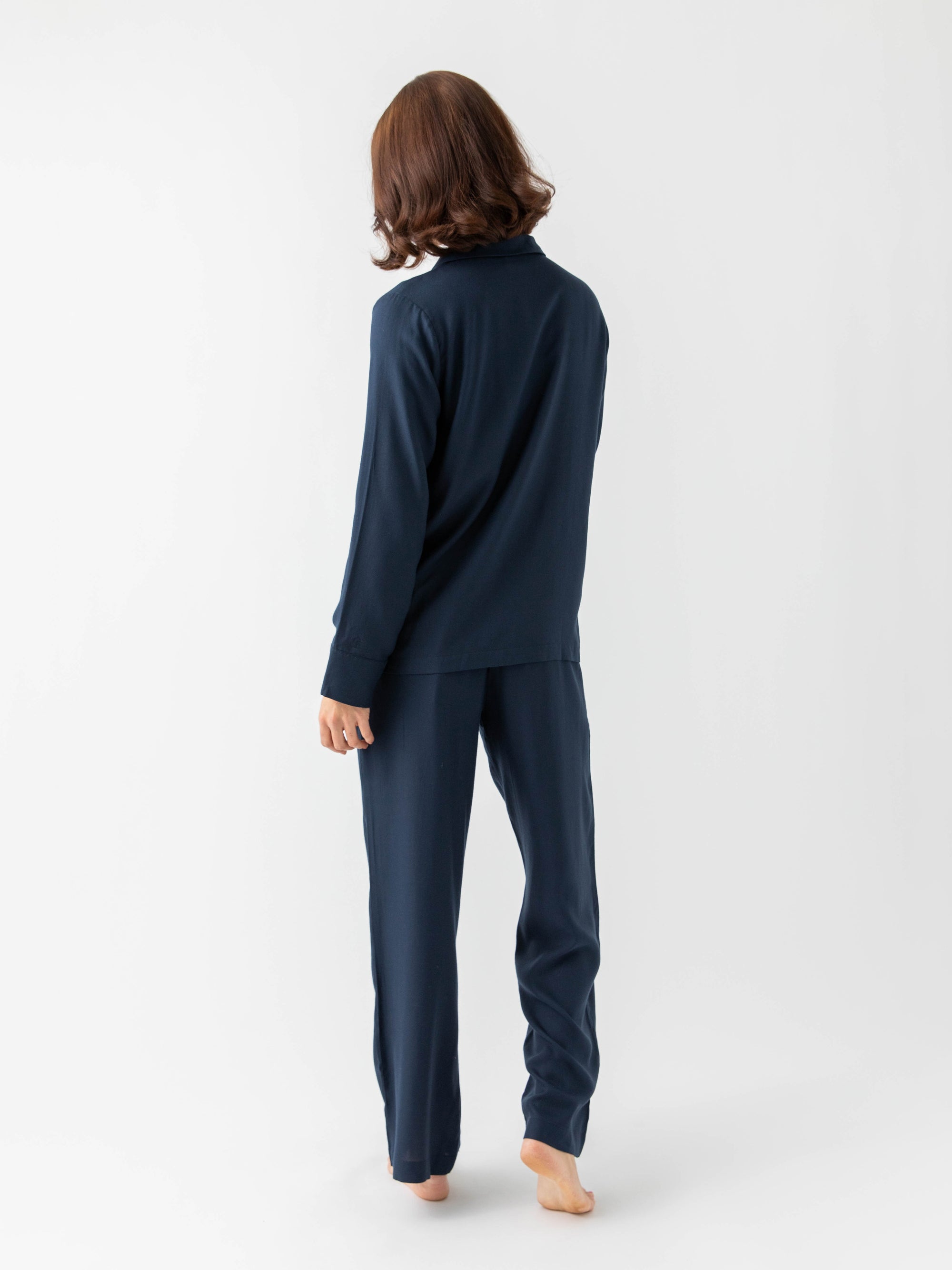 Woman wearing Eclipse soft woven pajamas with white background 