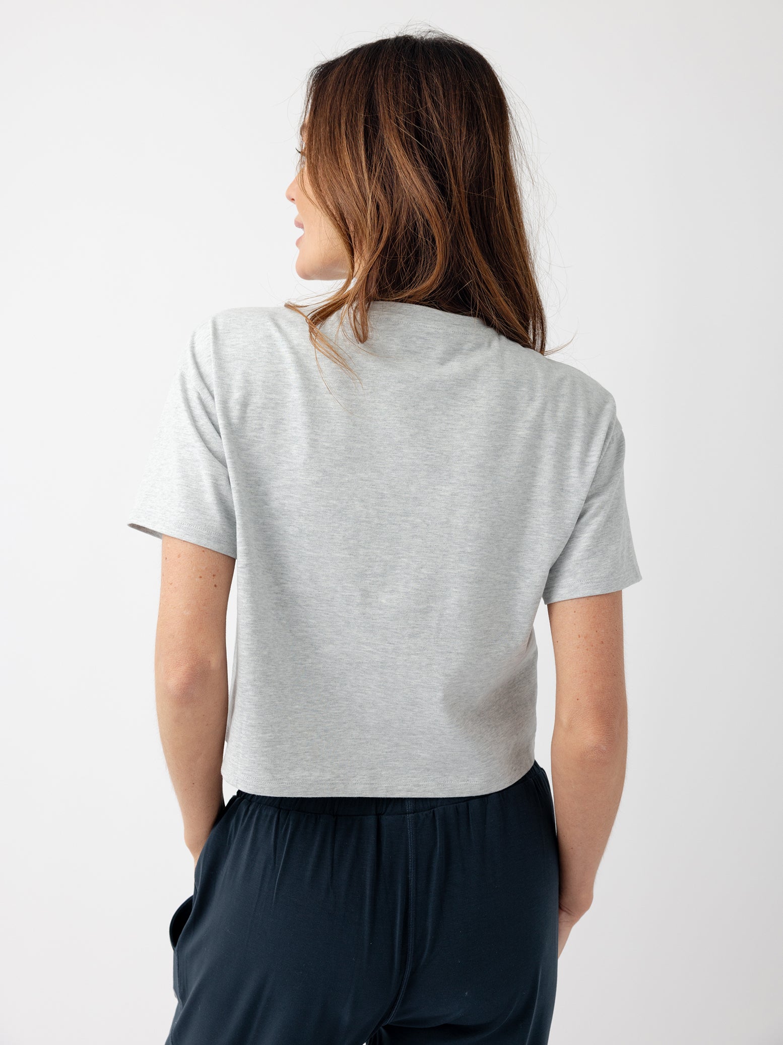 French Dove Heather All Day Cropped Tee. The photo of the All Day Cropped Tee is taken with a with a white background and is worn by a woman. 