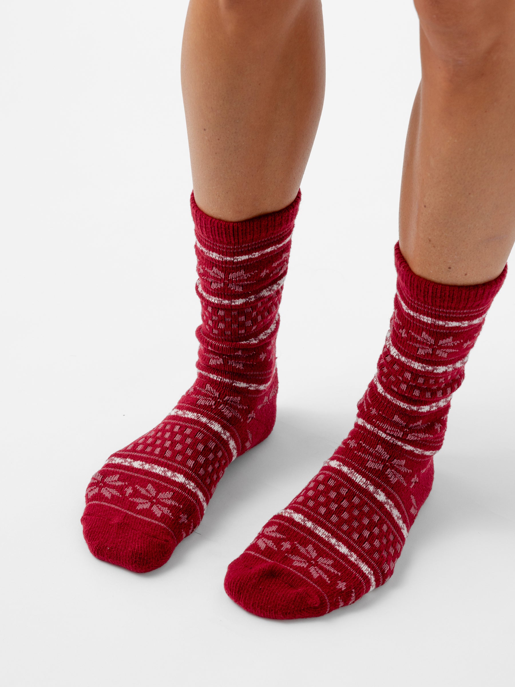 A person stands with a white background wearing Snowflake Plush Lounge Sock in Garnet |Color:Garnet 