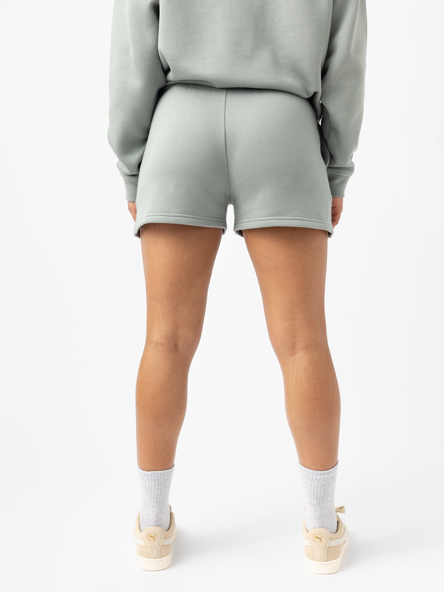 Haze CityScape Shorts. The shorts are being worn by a female model in skate shoes. The background it a white background. 