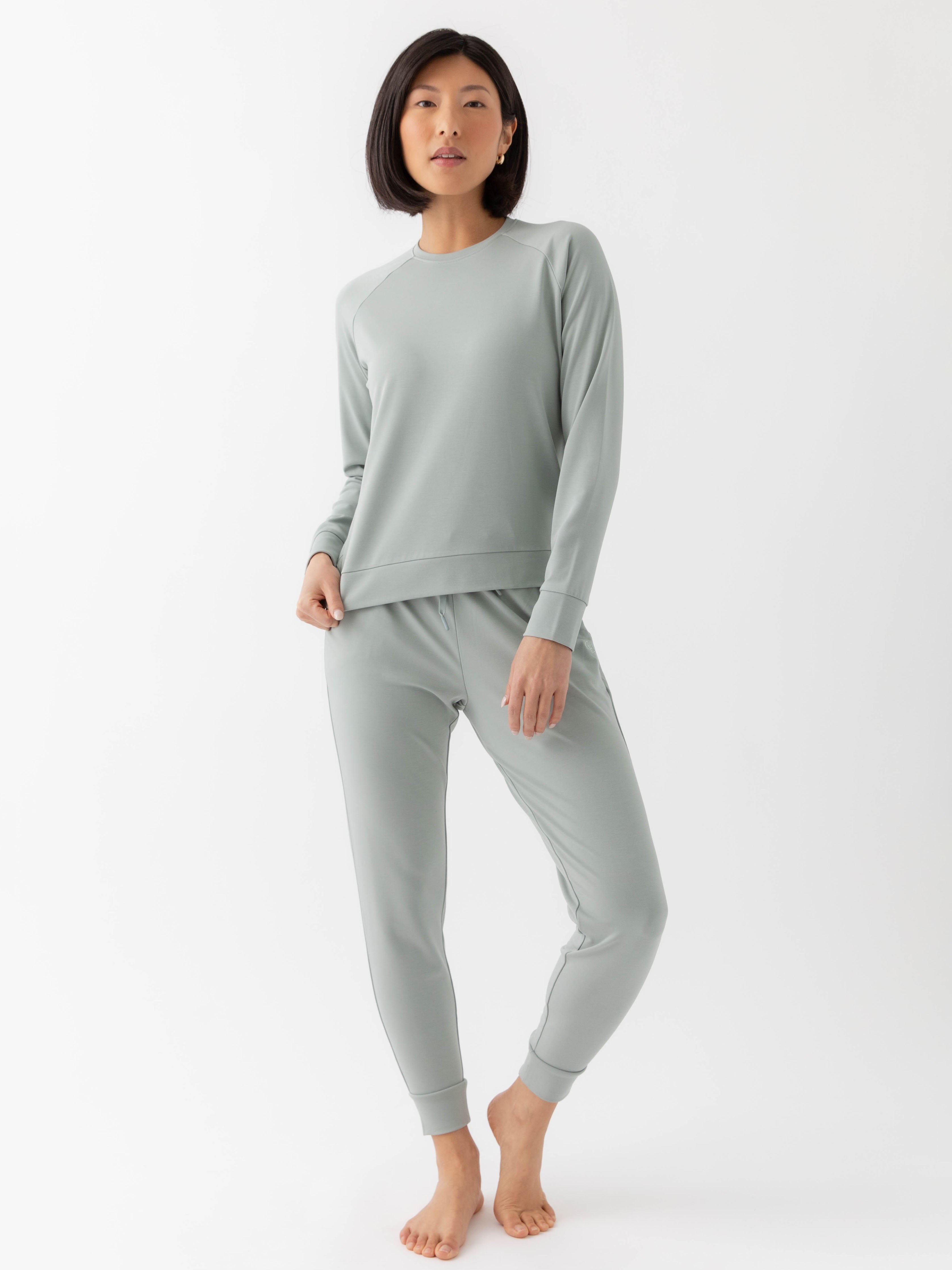 Haze Bamboo Jogger Set modeled by a woman. The photo was taken in a high contrast setting, showing off the colors and lines of the pajamas. 