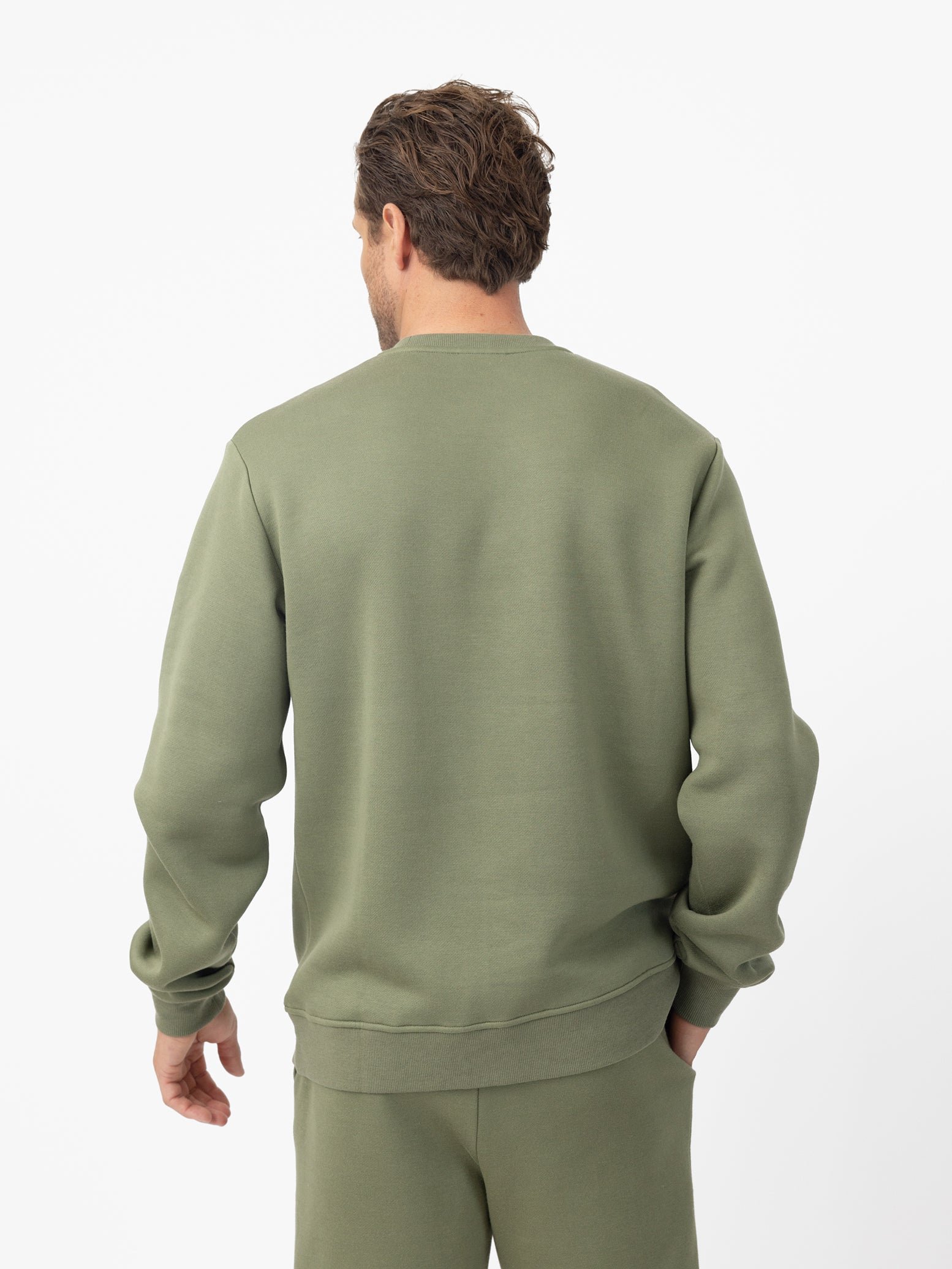 Man wearing Juniper cityscape crewneck with white background 