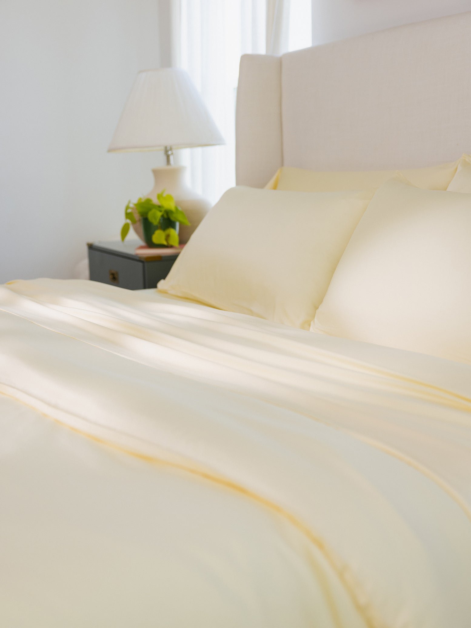 Partially made bed with lemonade bedding 