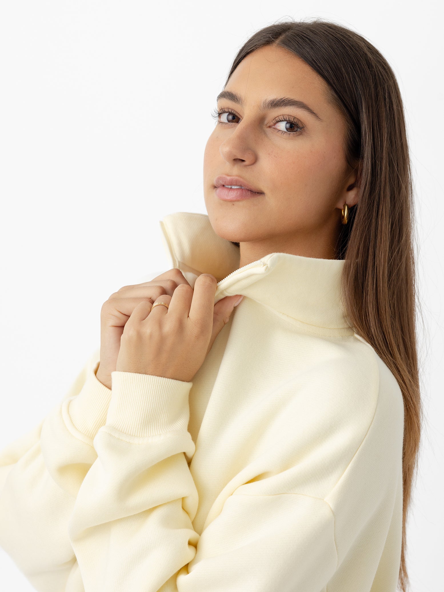 Lemonade CityScape Quarter Zip. The quarter zip is being worn by a female model. The photo was taken with a white background. 