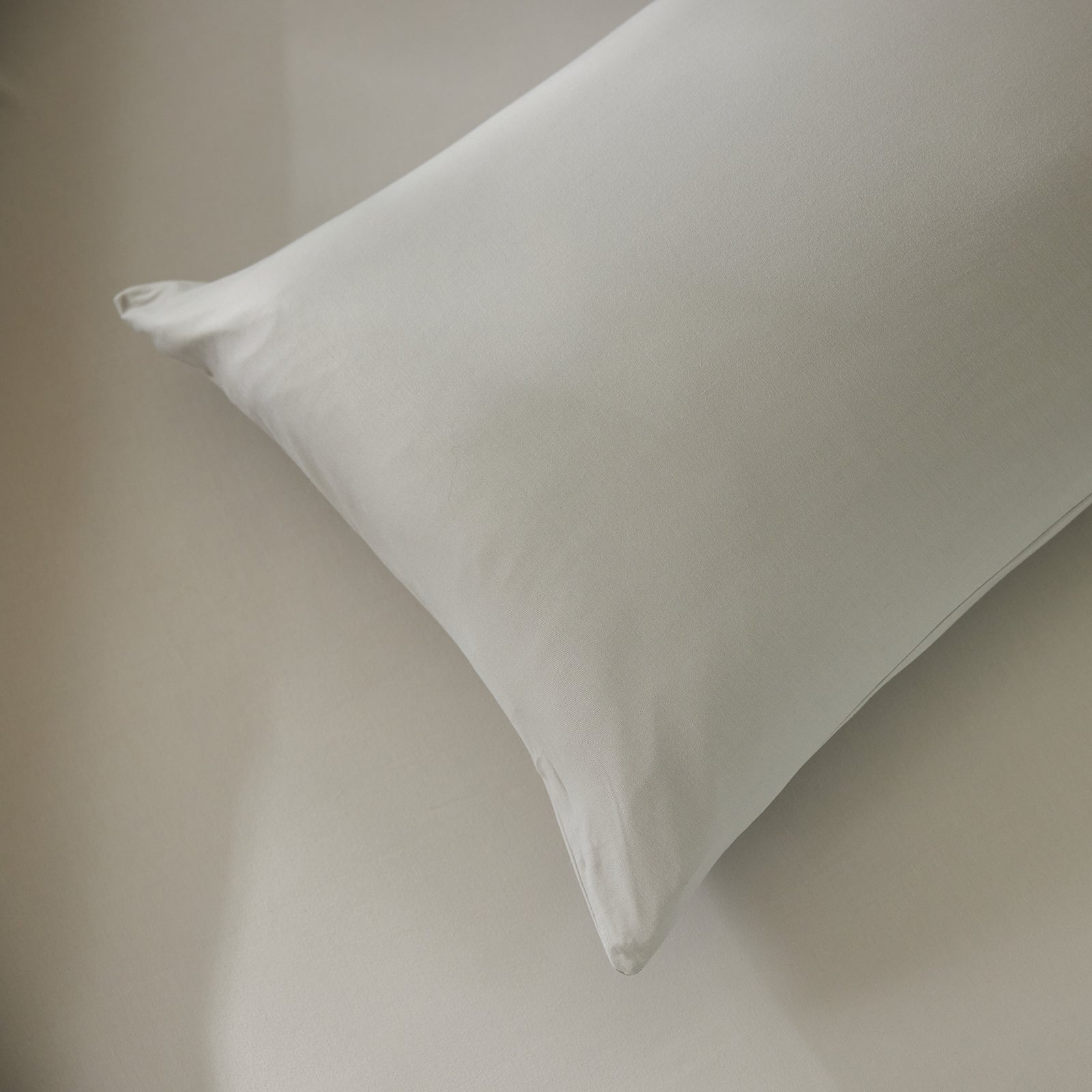 Close up of light grey bamboo jersey pillowcase and sheet 