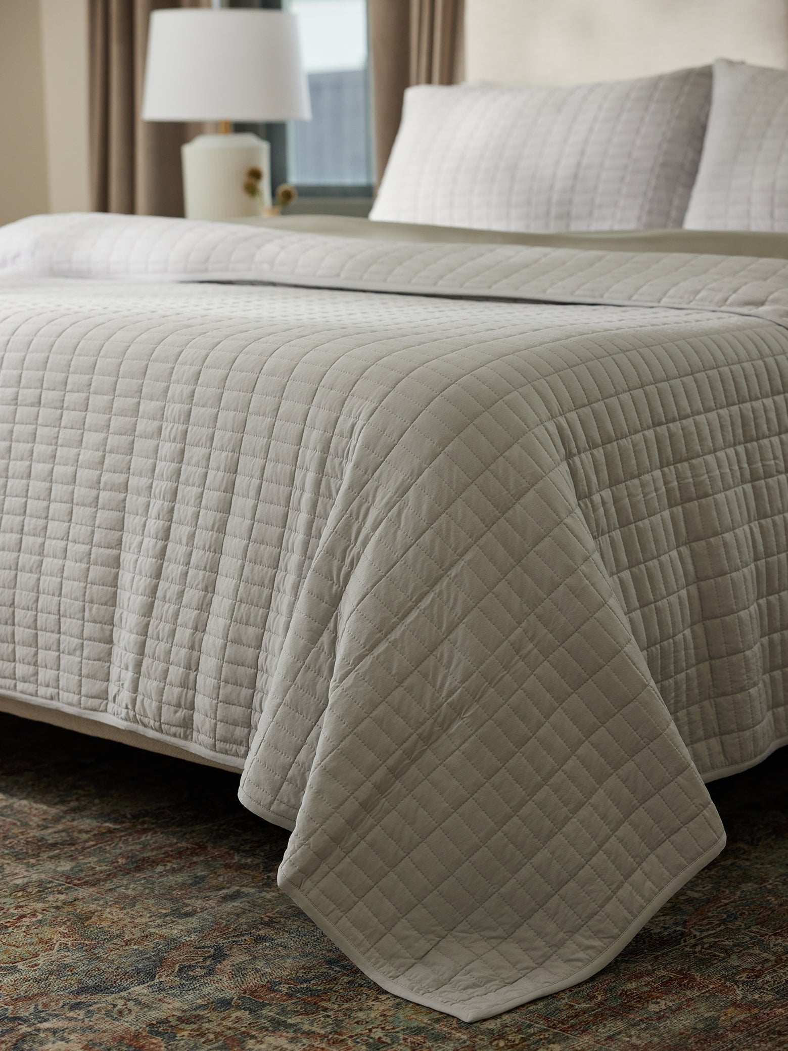 Bed made with bamboo jersey quilt in light grey 