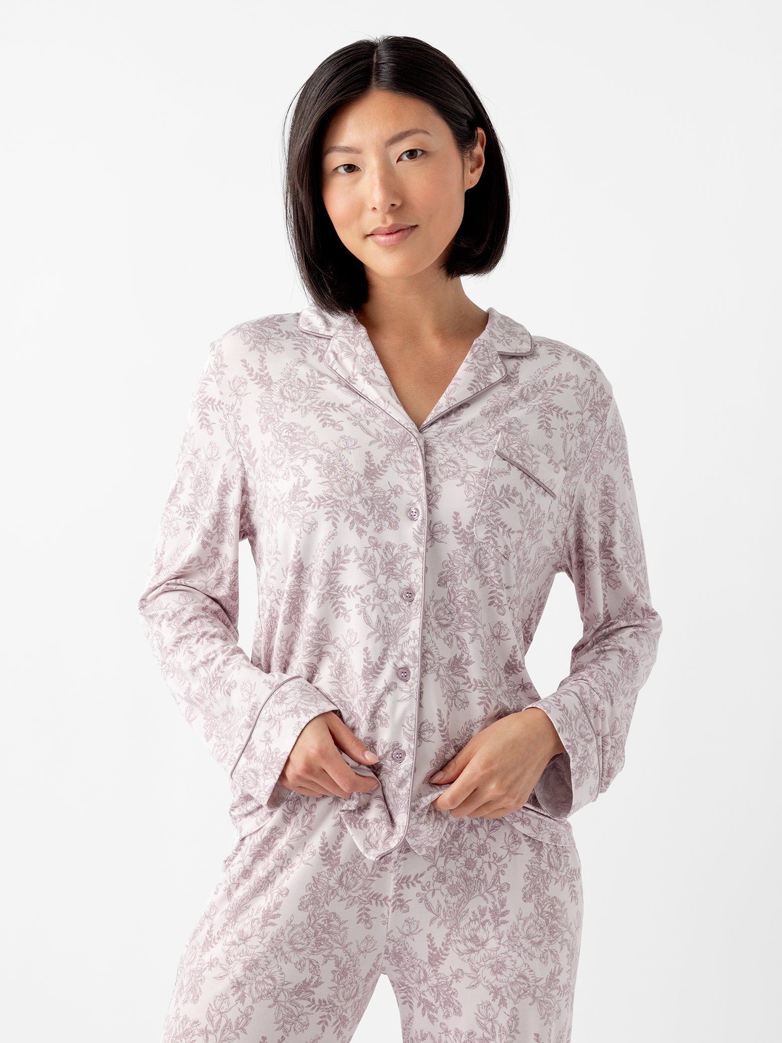 Woman wearing lilac toile pajama shirt with white background 