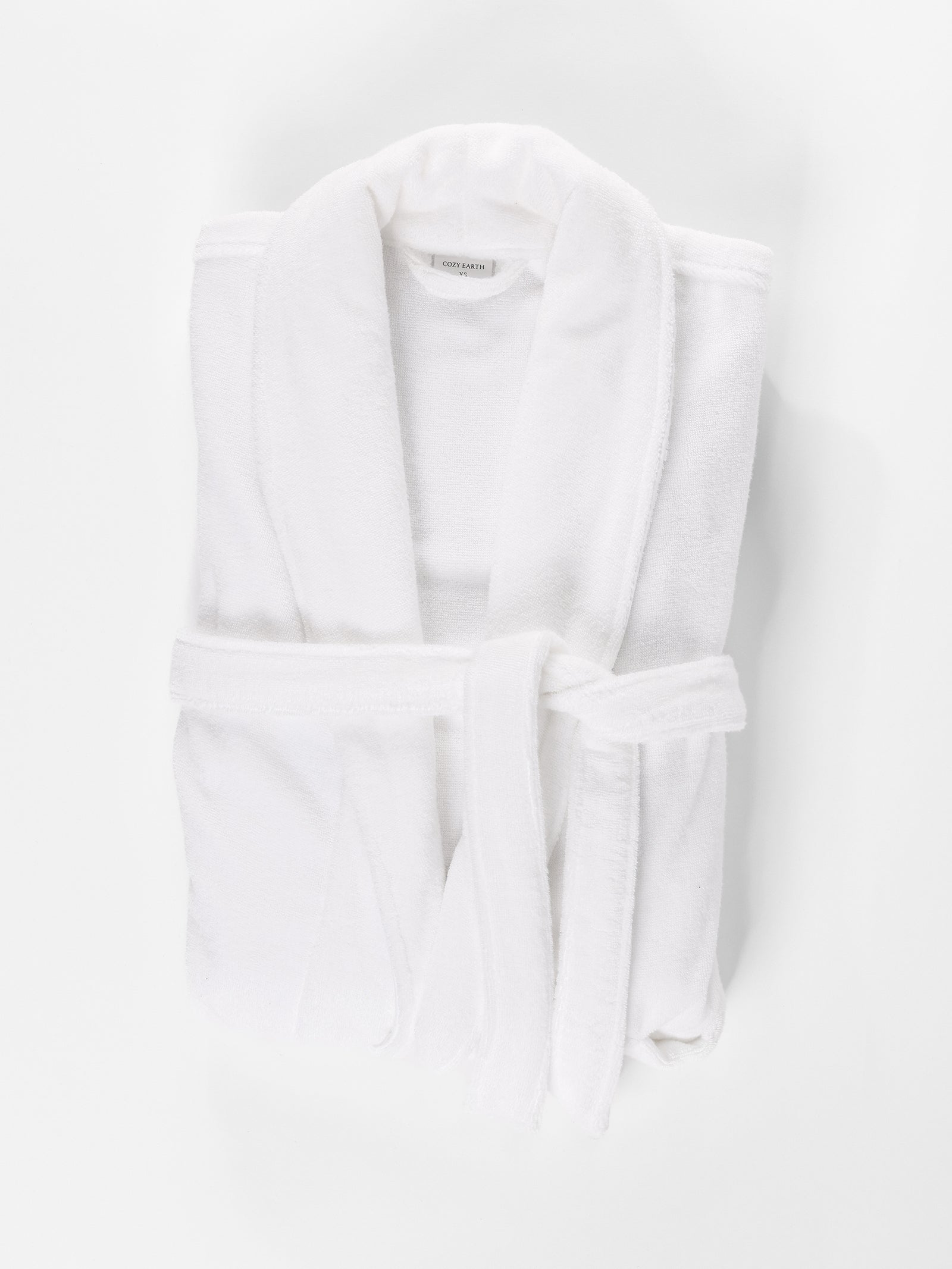 White bath robe folded with white background 