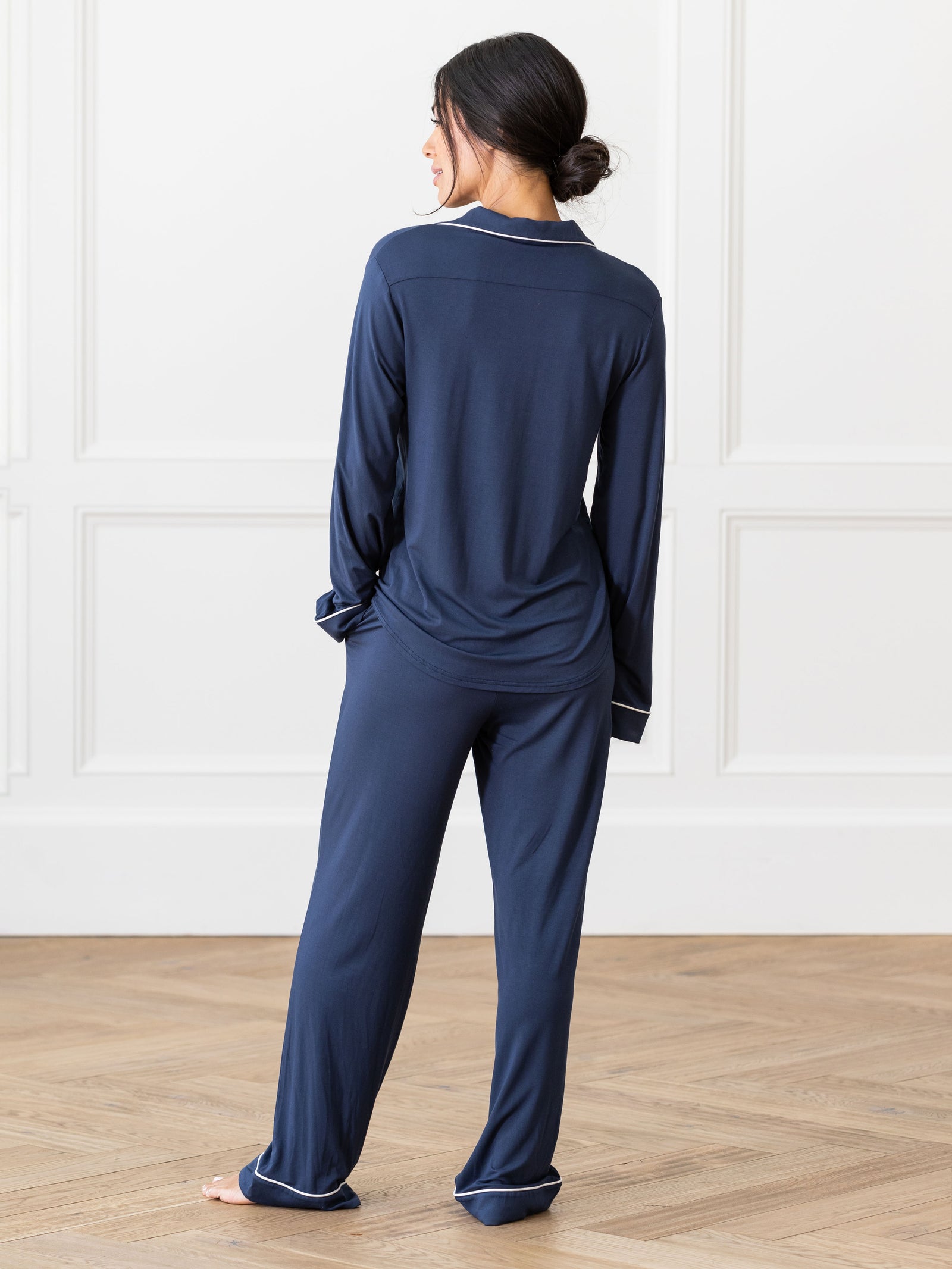 Navy Long Sleeve Pajama Set modeled by a woman. The photo was taken in a high contrast setting, showing off the colors and lines of the pajamas. 