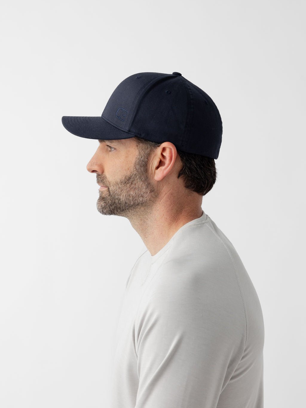 Side view of man wearing navy urban classic hat 