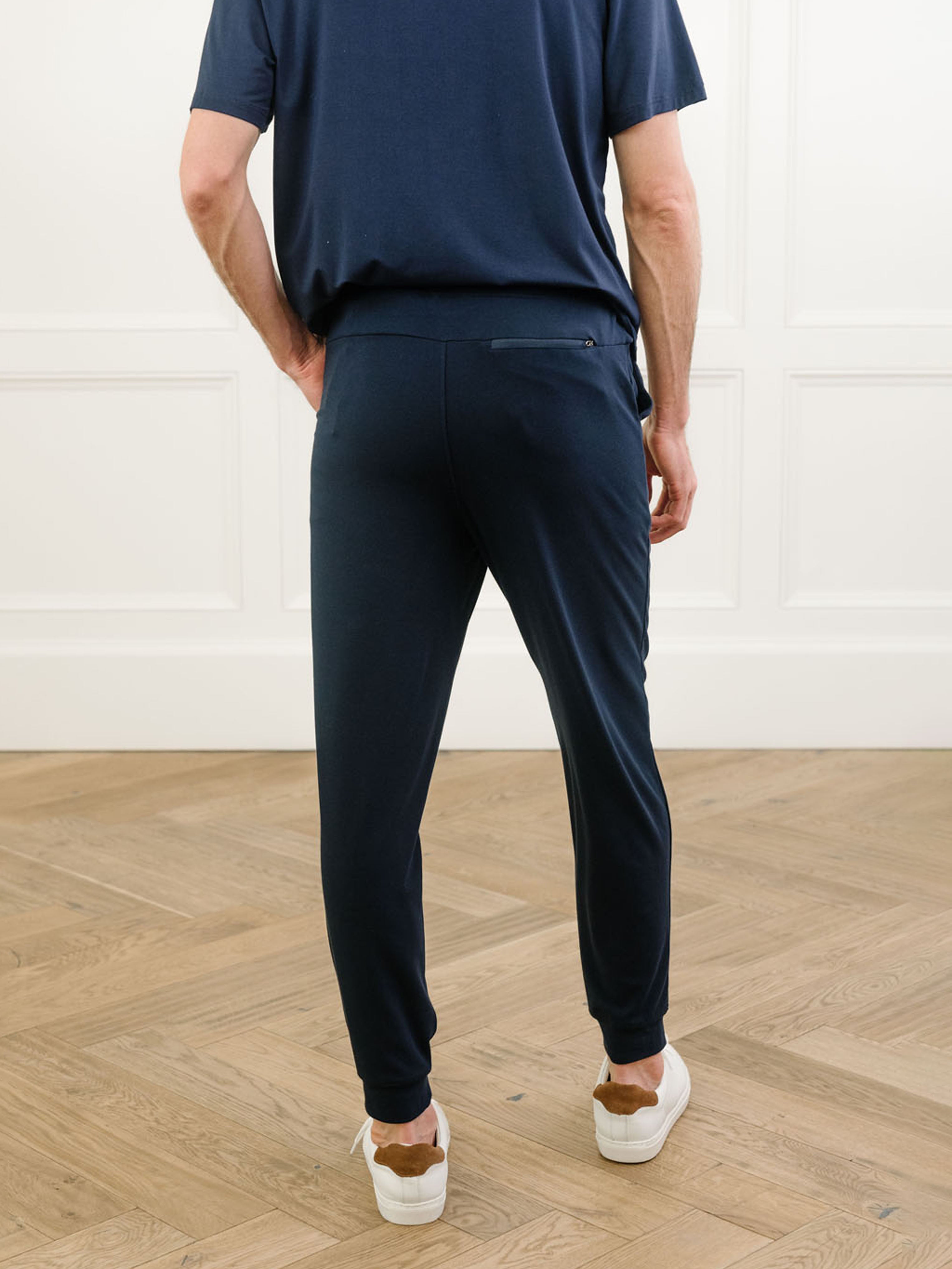 Navy Men's Bamboo Jogger Set. There is a man wearing the jogger set. He is standing in a well lit room in a home.|Color:Navy