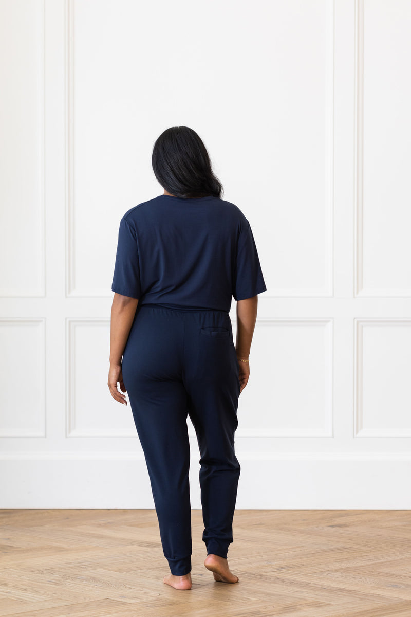Woman wearing Cozy Earth Bamboo Lounge Tee in dark blue. She faces backward