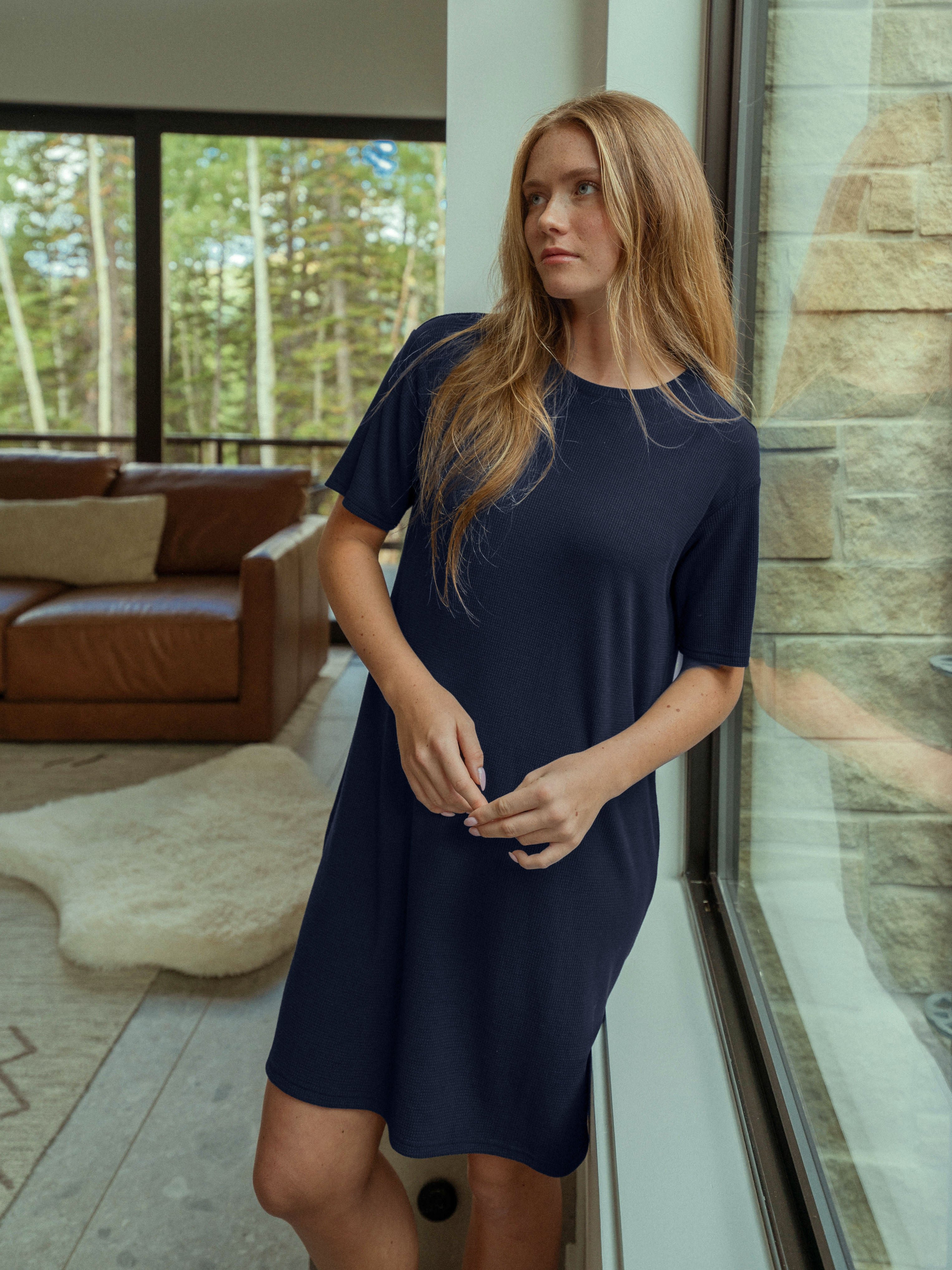 Woman posing in Waffle Knit Dress next to a window