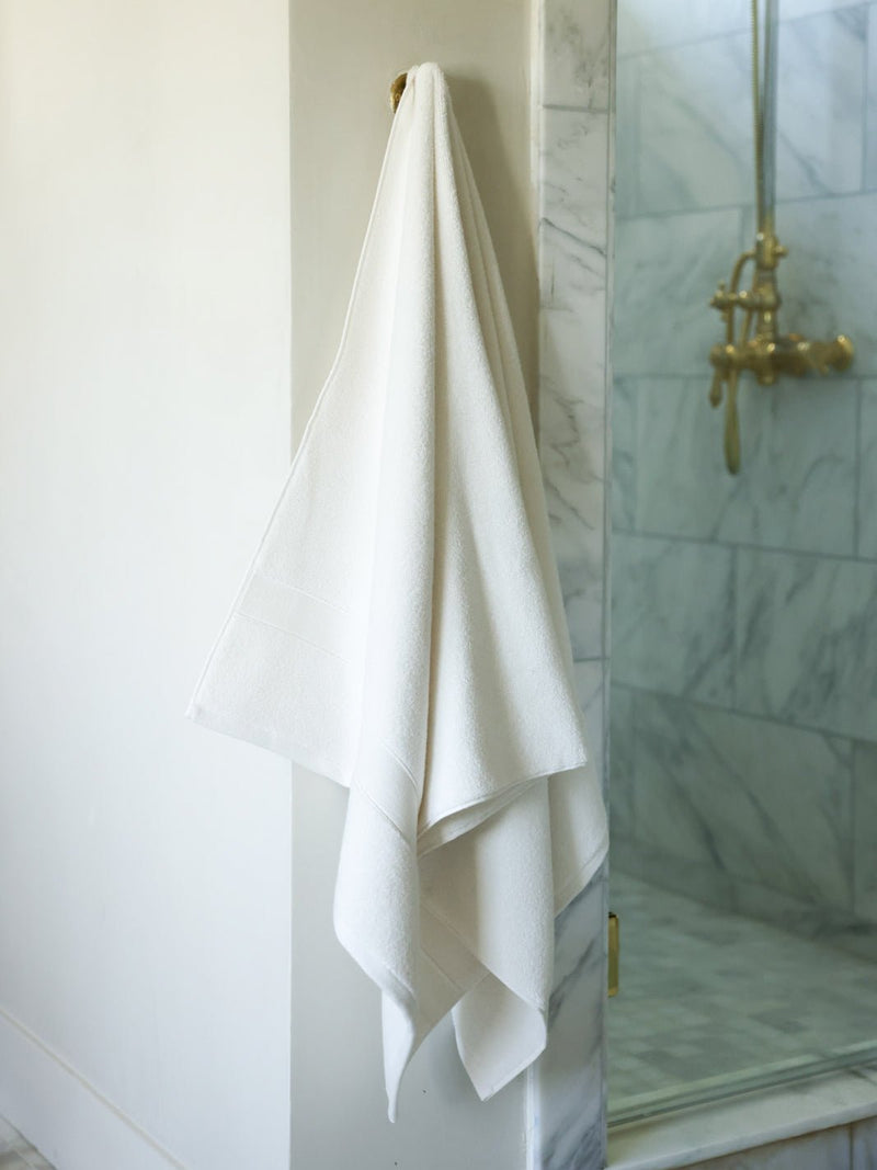 Seashell luxe bath sheet hanging next to shower