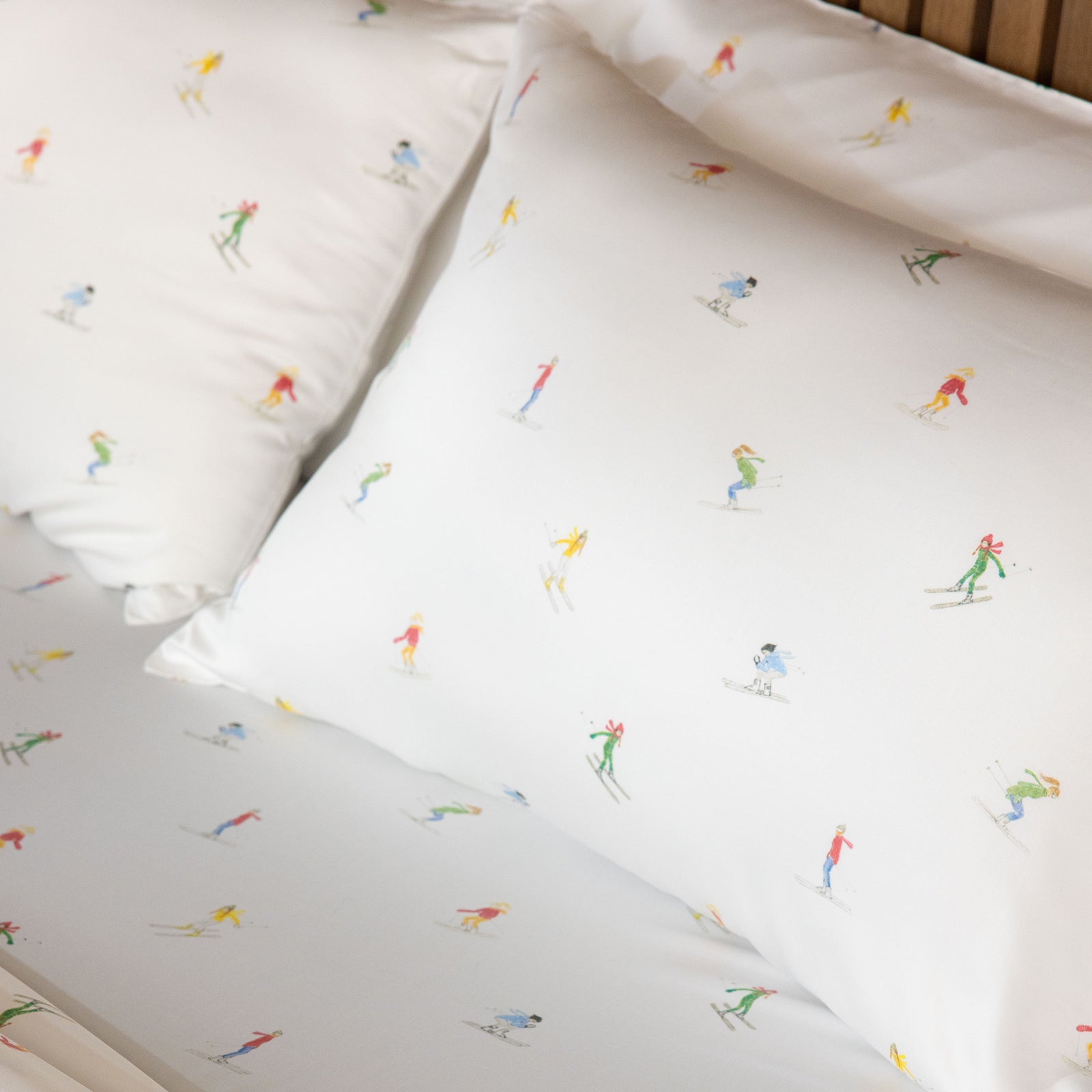 Close up of pillowcases on bed with skiers on them standard/king/body 