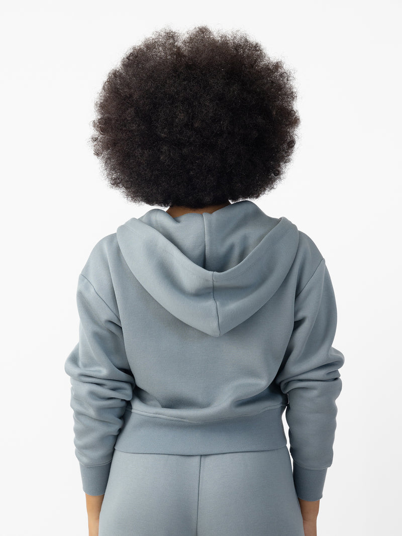 Woman wearing Smokey Blue  CityScape Cropped Full Zip with white background