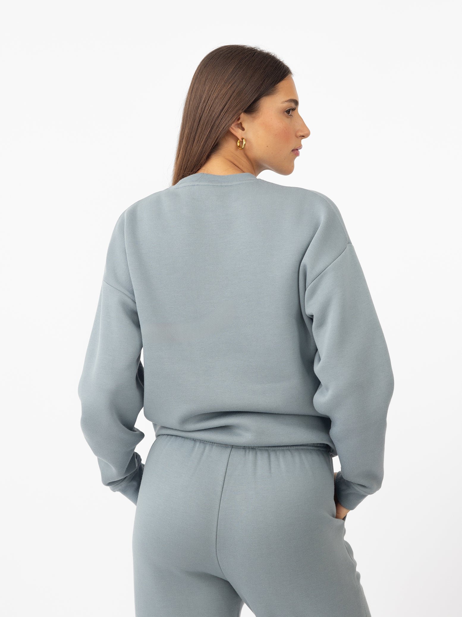 Woman wearing Smokey Blue CityScape Crewneck with white background 