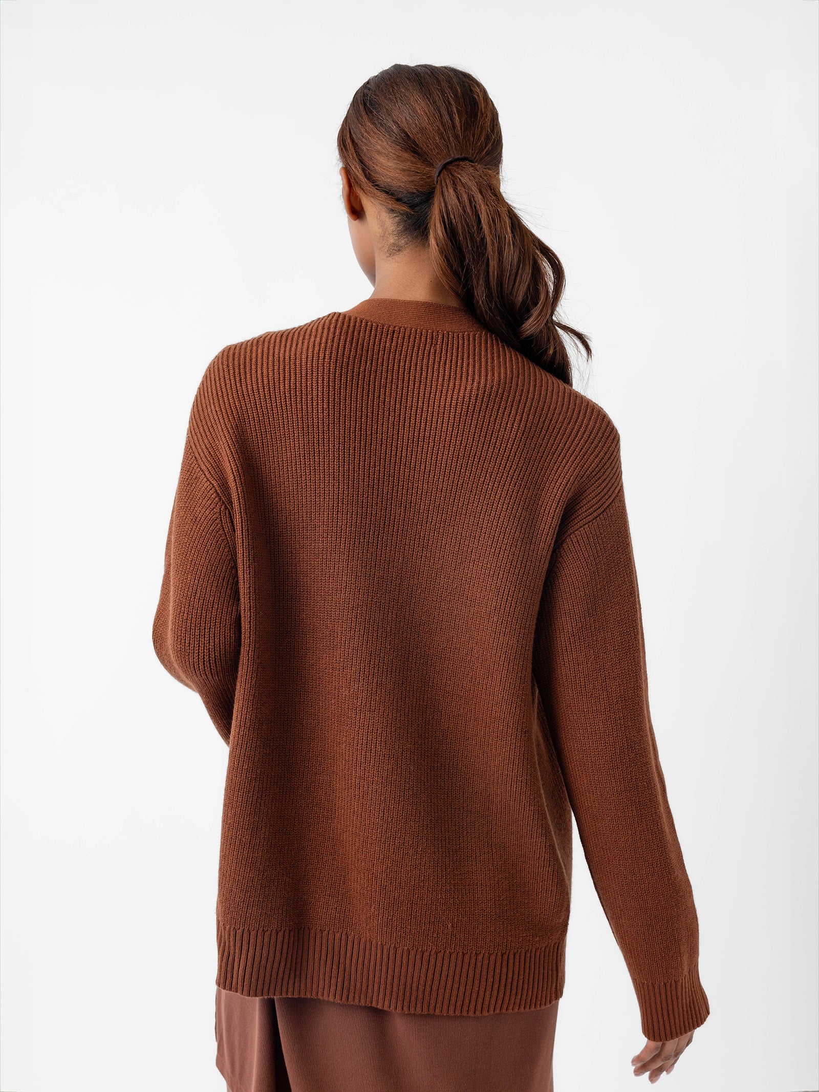 Woman showing the back of Oversized Classic Cardigan - Spice 