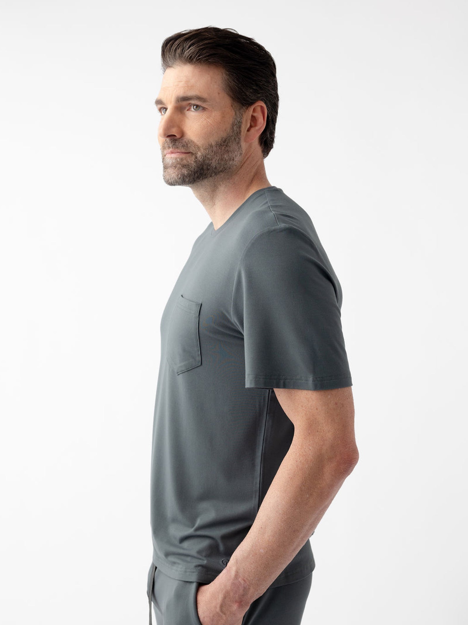Side view of man wearing storm pajama shirt with white background 