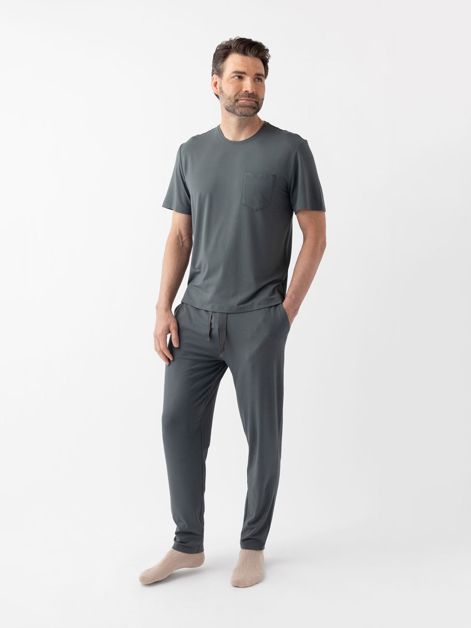 Man wearing storm pajama shirt and pants with a white background 