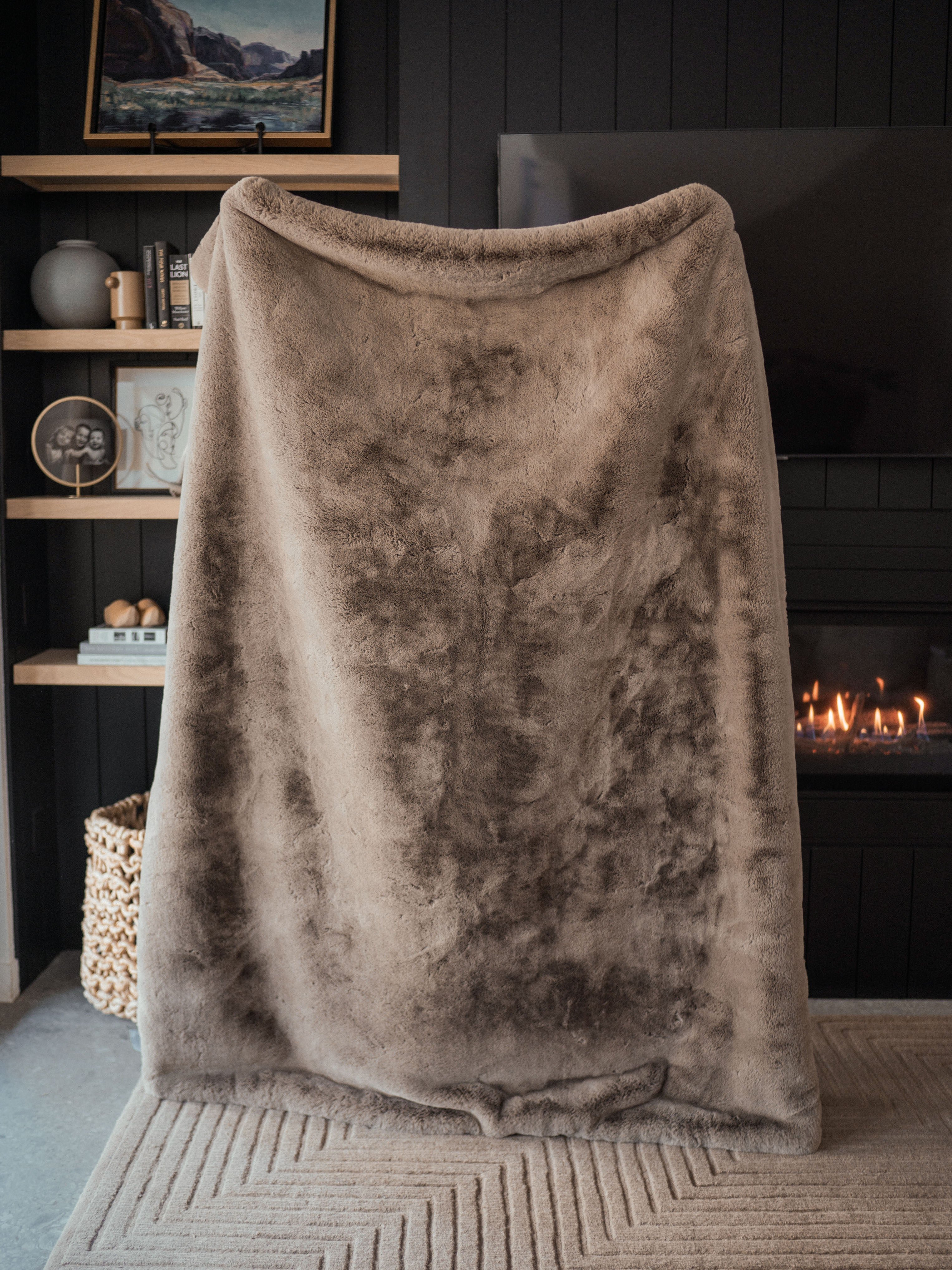 Person holding up the Cuddle Blanket in the Oversized Throw size 