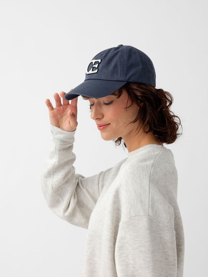 Side view of woman wearing washed navy vintage cap