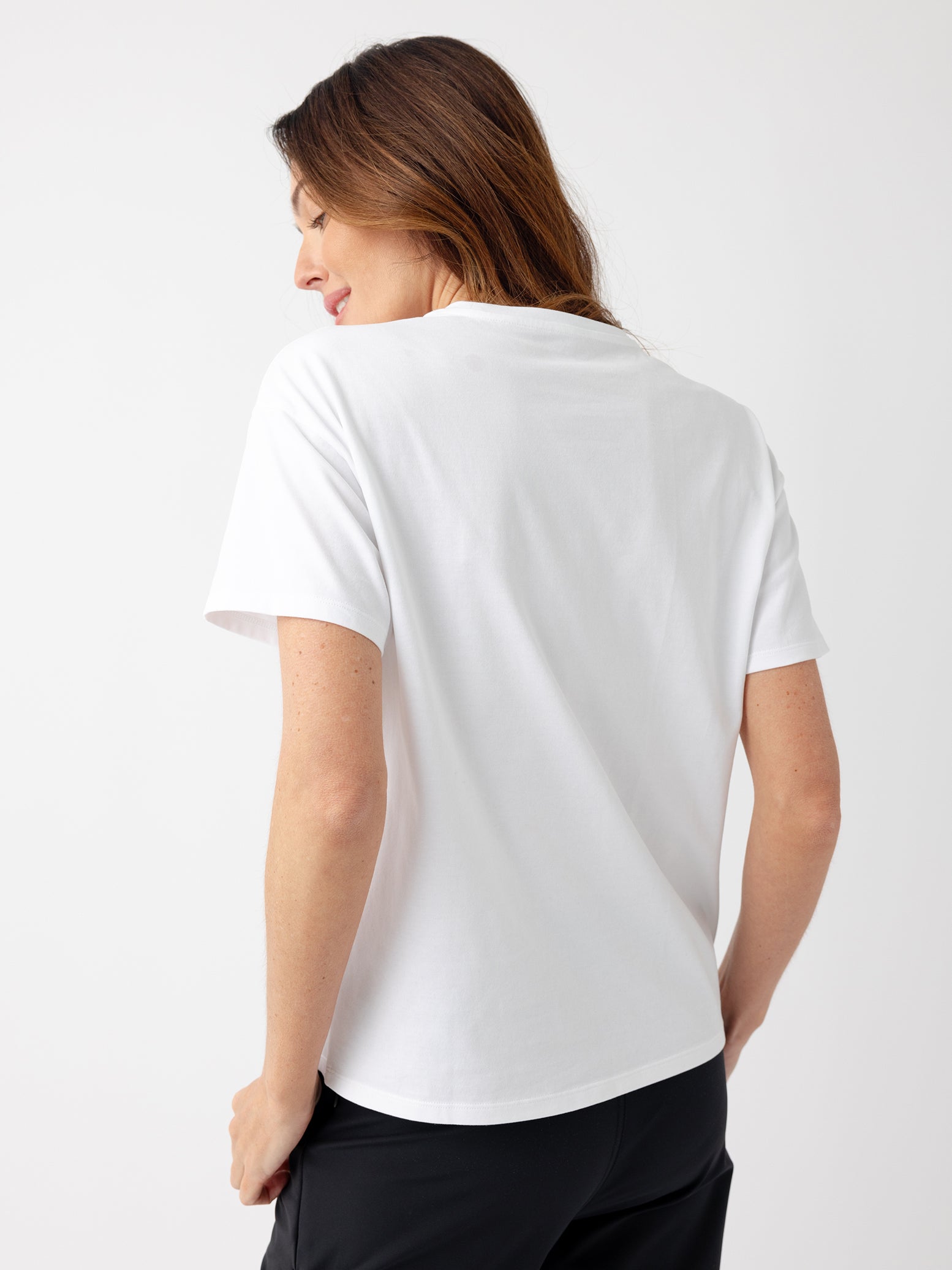 Back of woman wearing white tee 