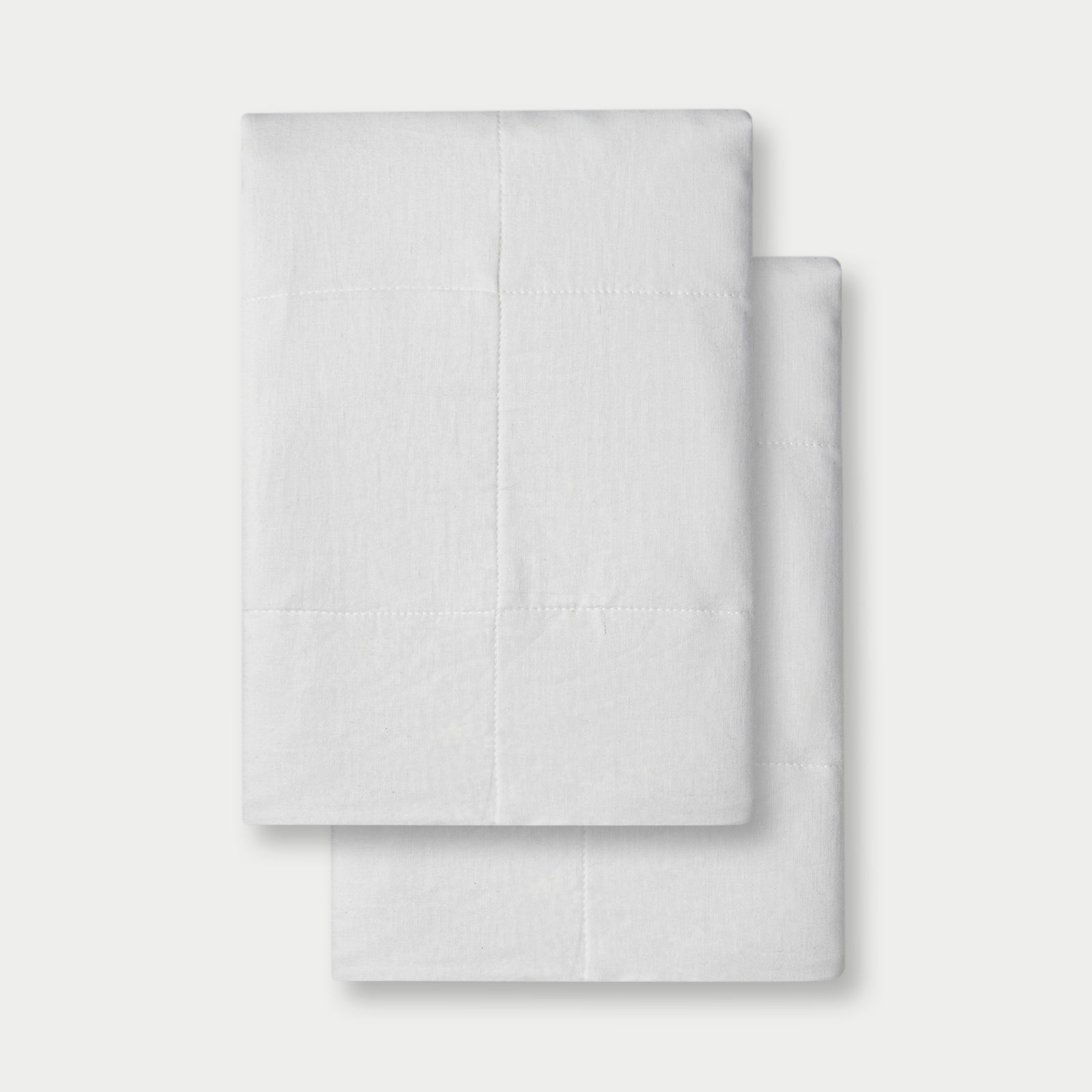 White Linen Box Quilt Sham neatly folded over white background. 