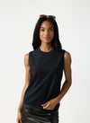 A woman with dark hair and sunglasses on her head wears Cozy Earth Women's All Day Sleeveless Tee in Jet Black. She's shown from the hips up in front of a white background. |Color:Jet Black