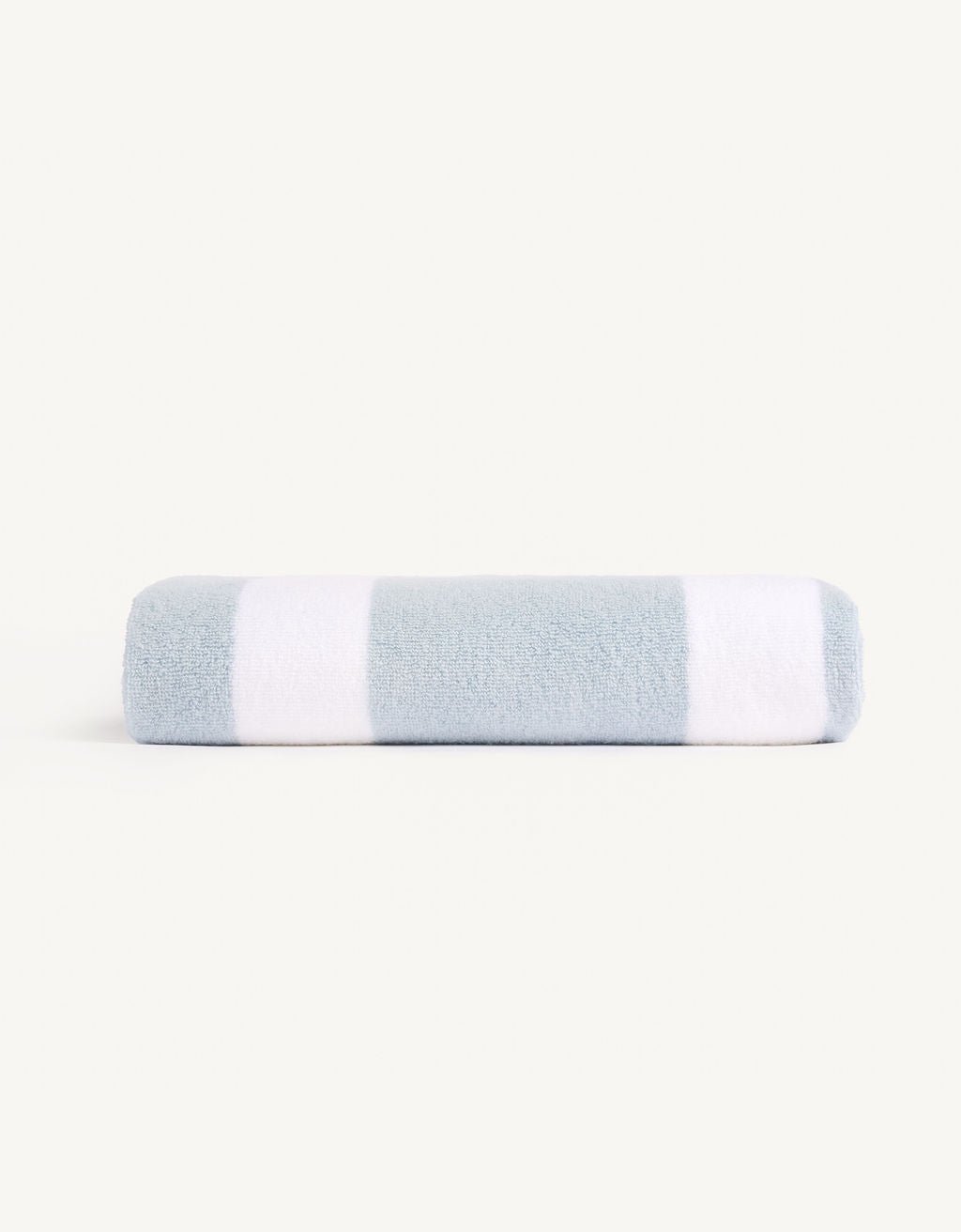 A neatly rolled Cozy Earth Classic Stripe Resort Towel with alternating light blue and white stripes is placed on a plain white background. |Color:Breeze